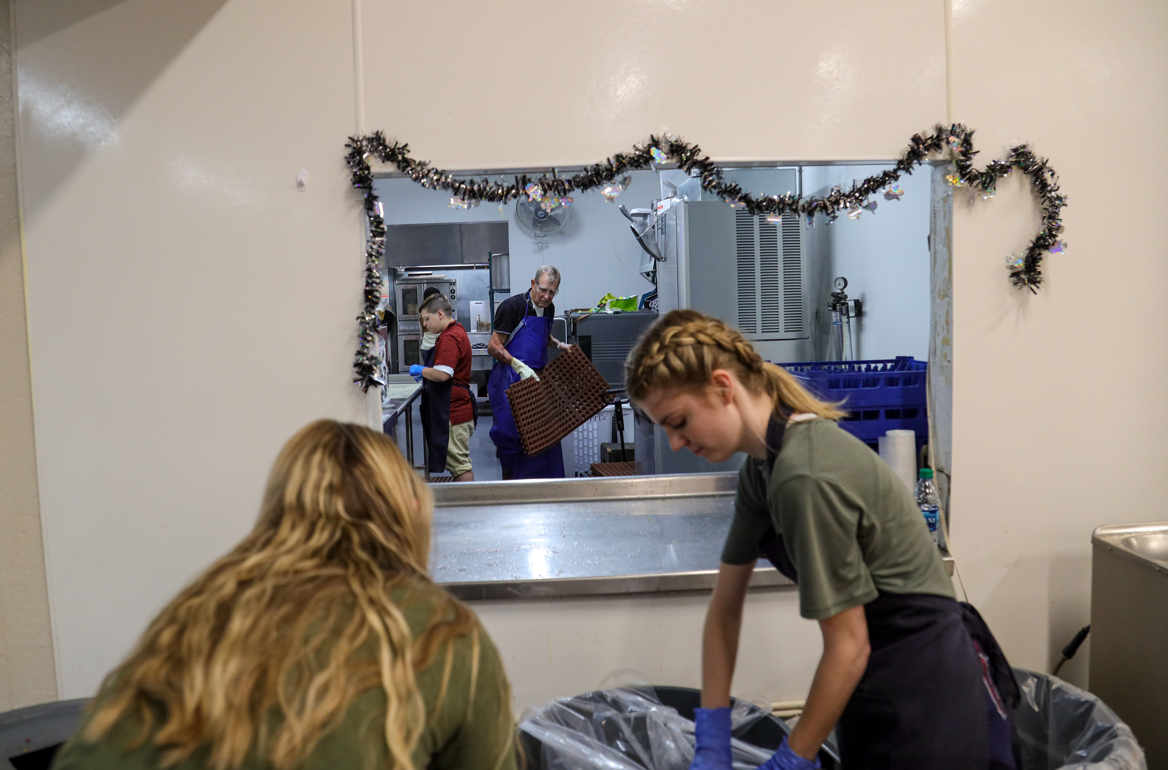 Volunteers clean up after preparing and serving the Guests. Thousands of volunteers from different schools and organizations come every year to help out in this amazing ministry.