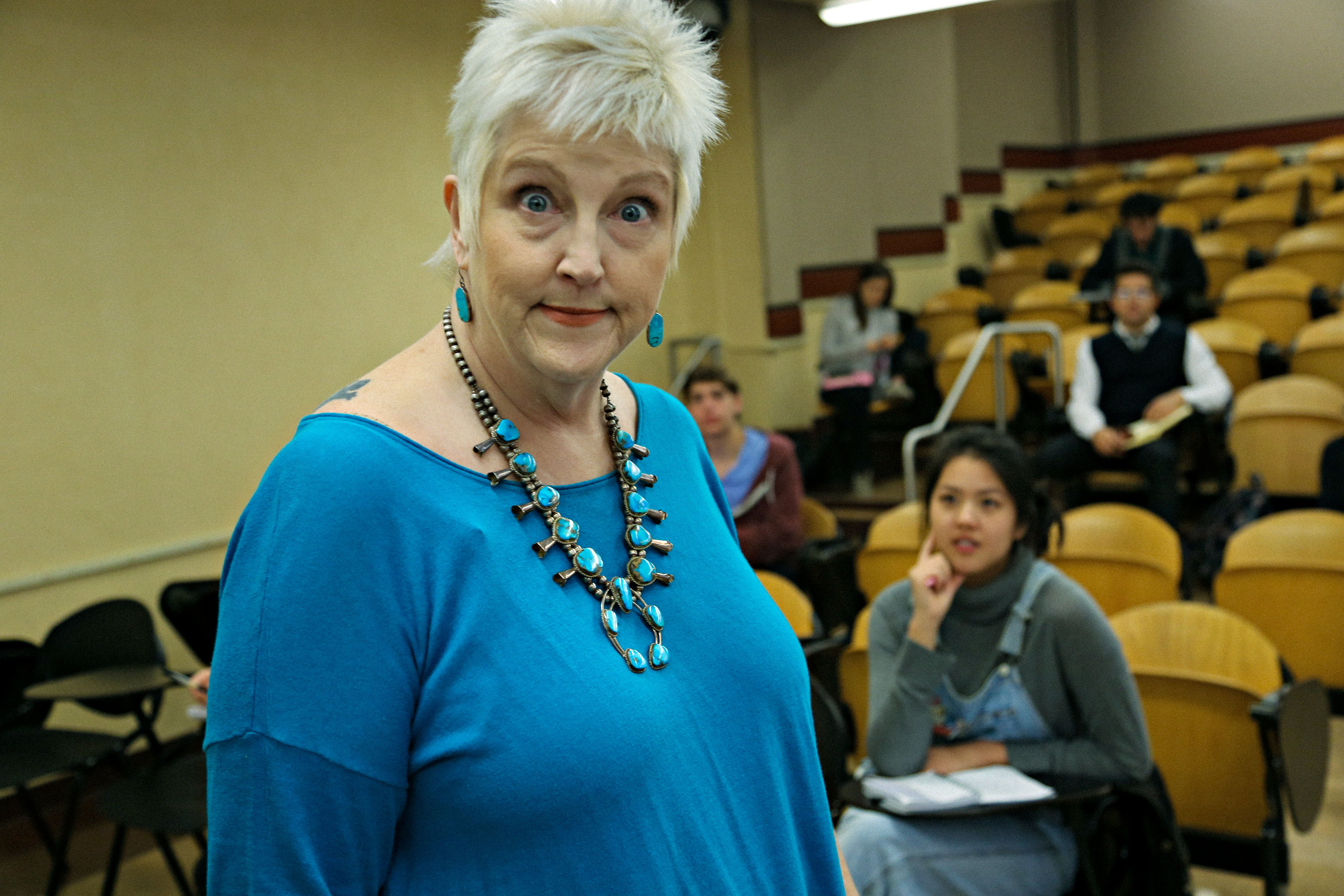 Kate McIntyre as the professor with her class on set for the "Philosophical Approach to Enlightenment"