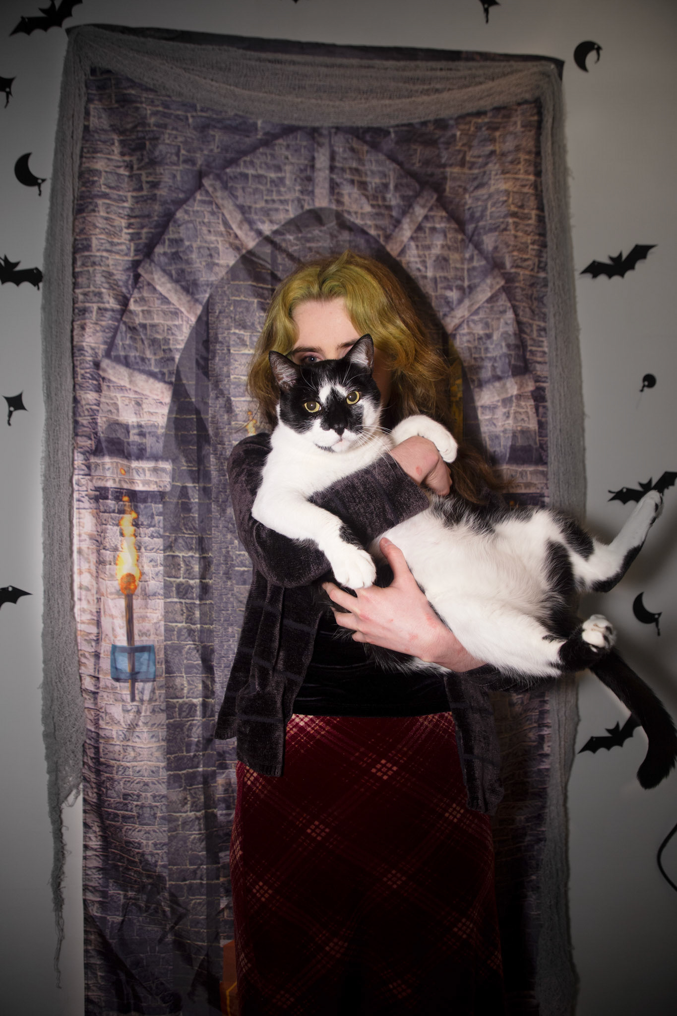 host Esther Grover holding Bandersnatch in front of the photo backdrop