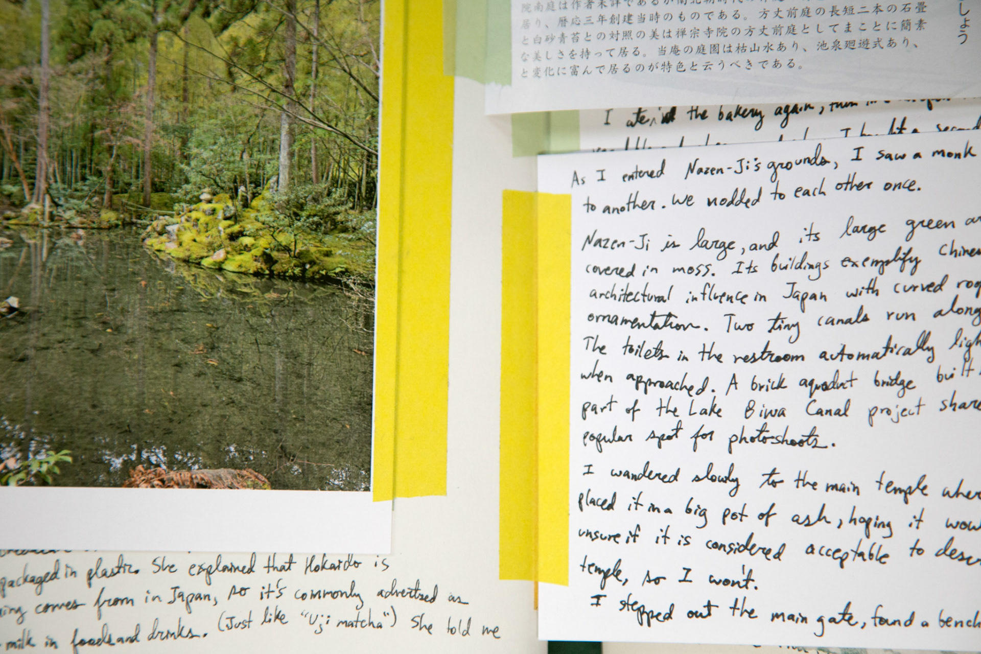 some postcards and other printed material affixed with washi tape