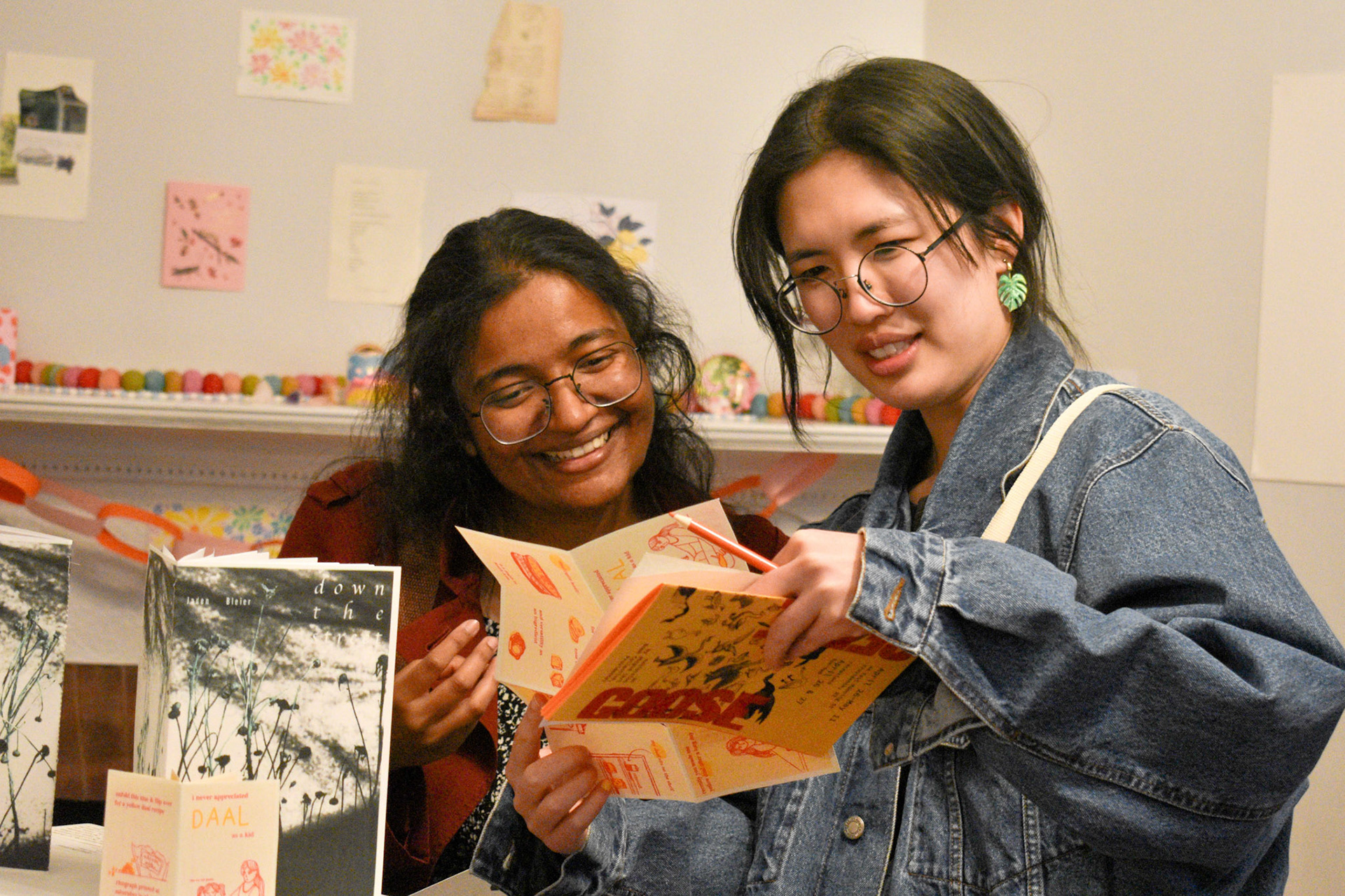 attendees interact with Areez Khan and Harshini Venkatachalam's zine "daal" - photo by Jamie Potter