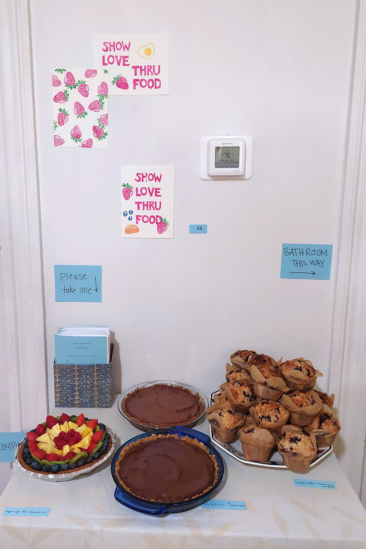 "show love thru food" (blockprint), recipe book, and desserts (tofu chocolate pie, vegan & gf tofu choc pie, cheesecake fruit tart) by Hannah Bashkow