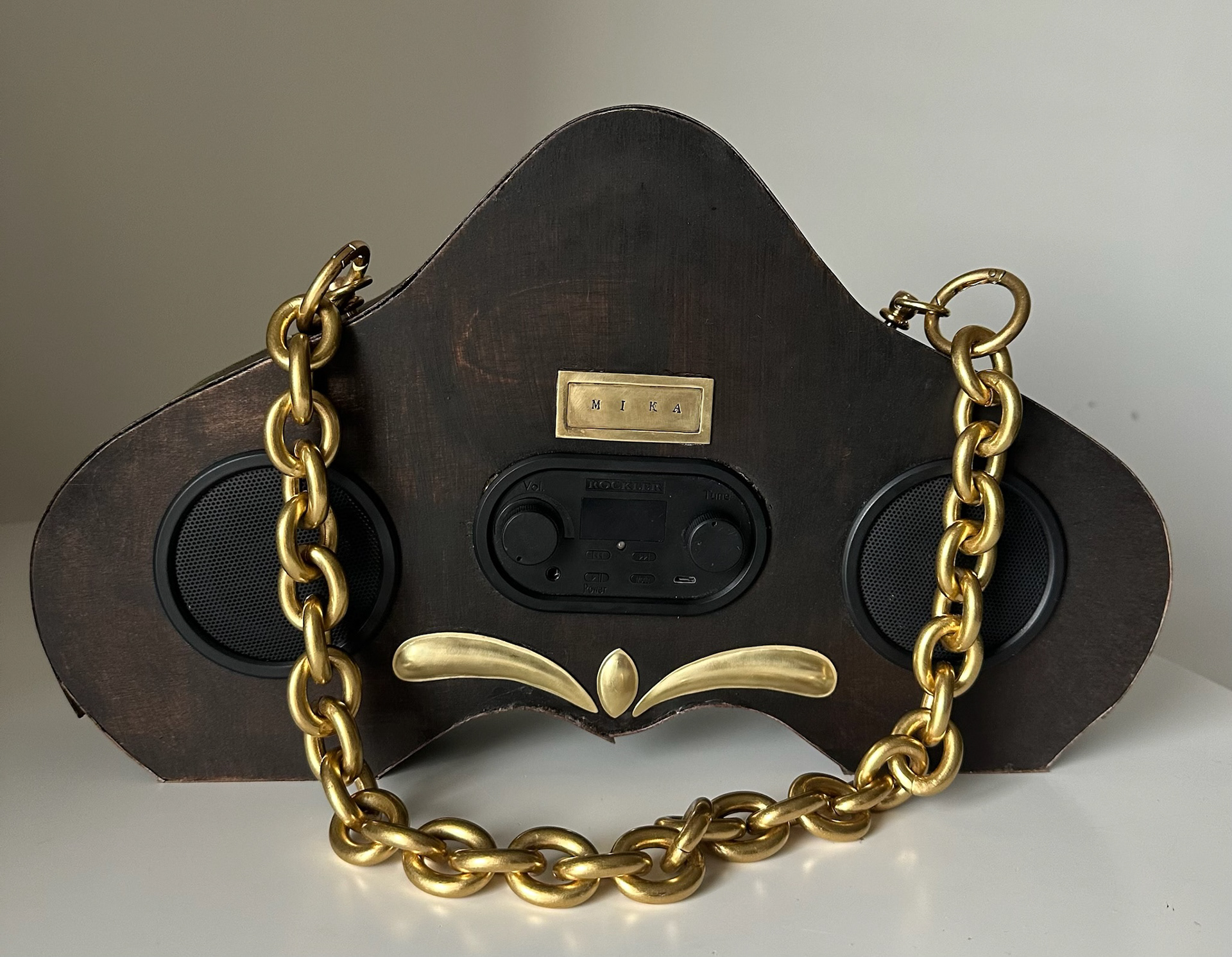 purse front, brass embellishments made from hydraulic press technique, and a stamped signature nameplate
