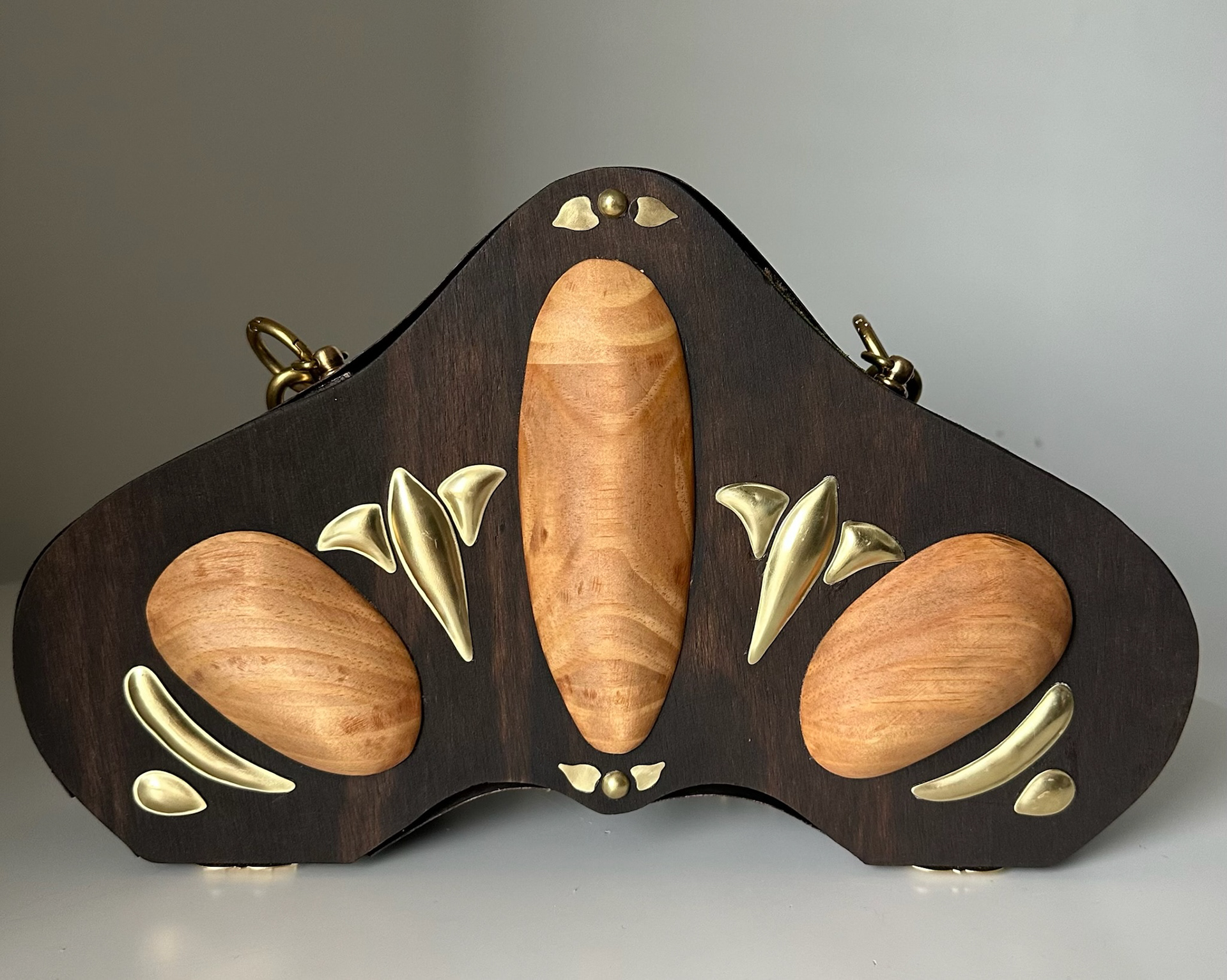 purse back, brass embellishments made with hydraulic press technique