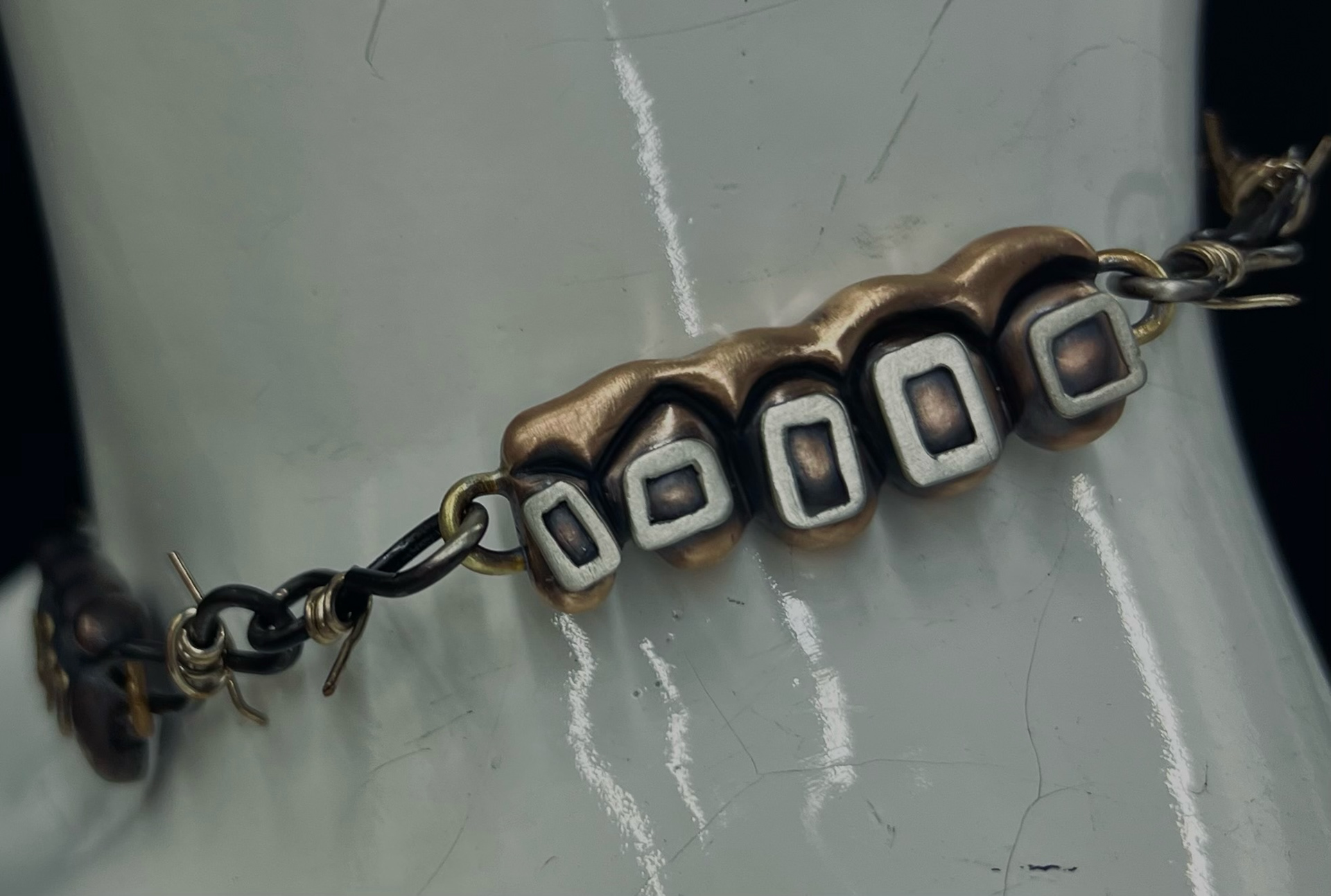 "chains on my braces" - hand carved in wax, cast in ancient bronze, nickel silver, brass - may 2023