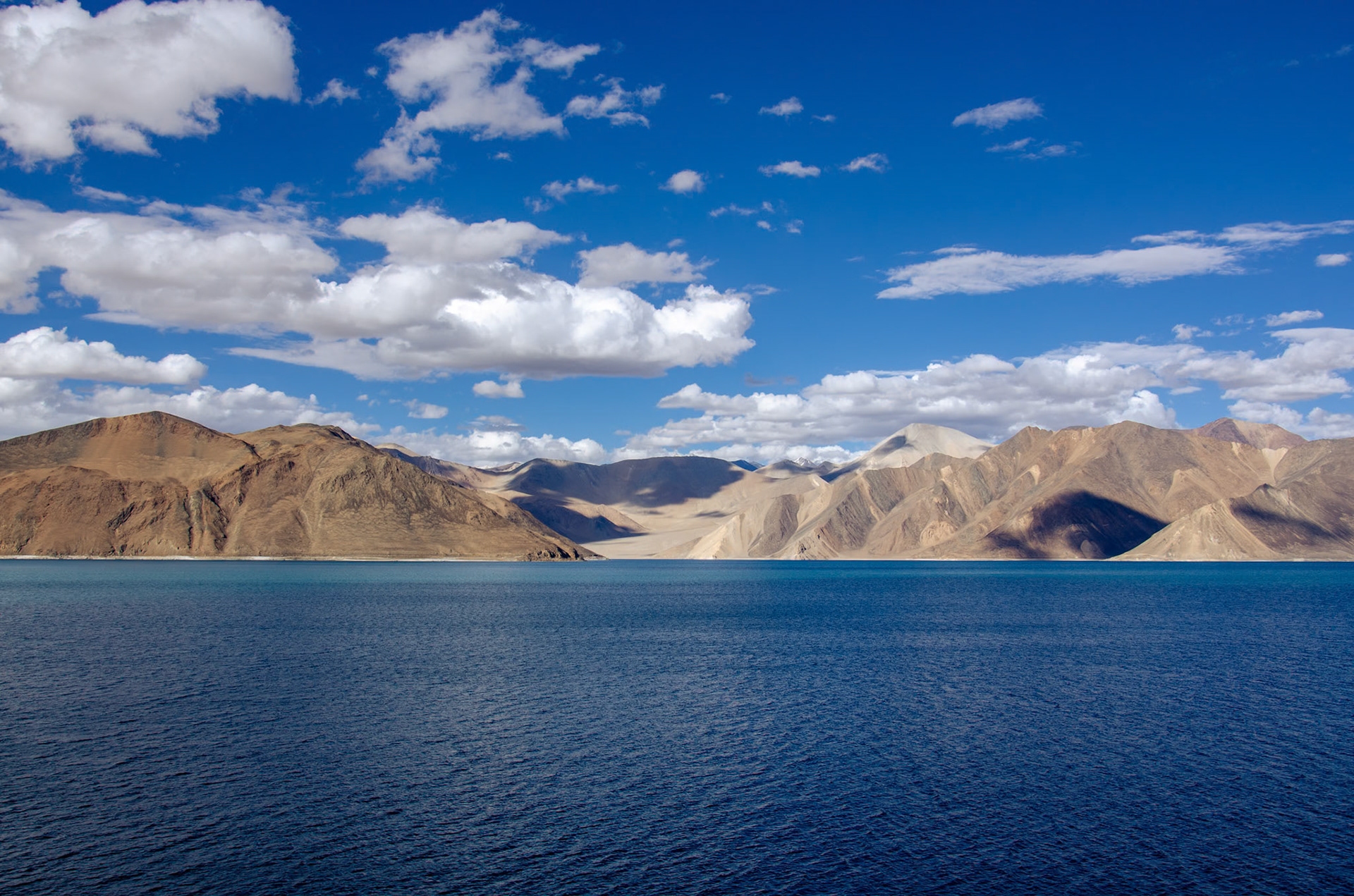 Pangong Tso or Pangong Lake is situated at an altitude of almost 4350 m or 14272 ft. It is the world’s highest salt water lake. Almost 160 km (approx. 100 miles) in length, one-third of the lake lies in India and the other two-thirds in China. The turquoise blue colour of the water stands in stark contrast to the arid mountains surrounding it.​​​​​​​