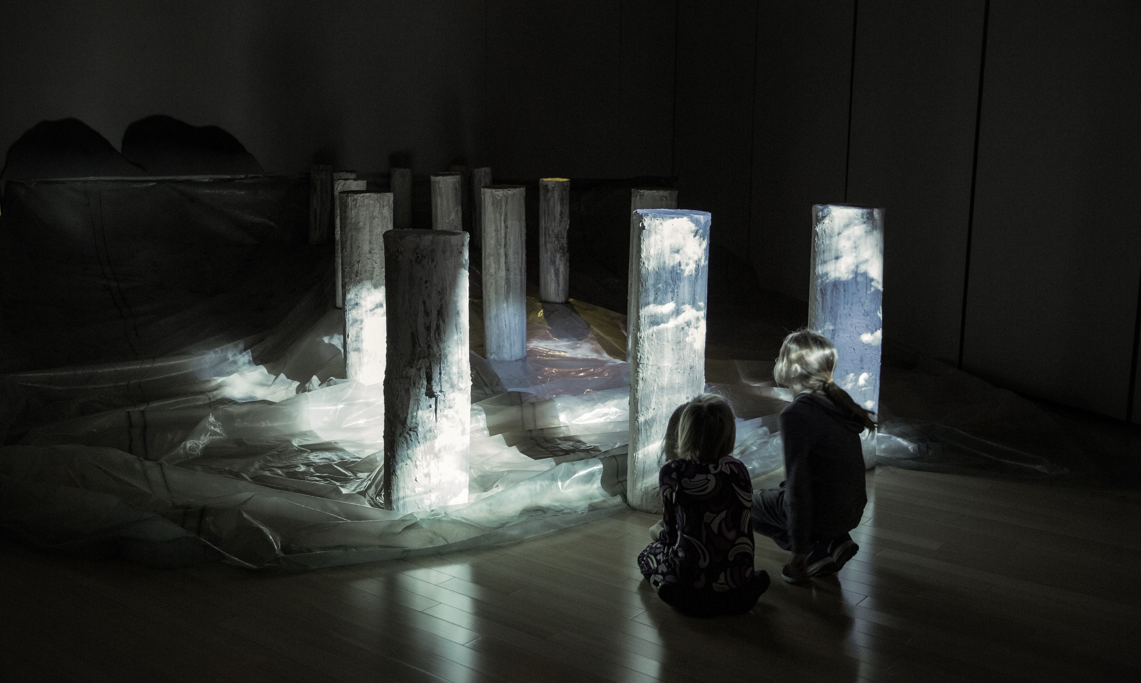 In Hindsight: Clouds meet the ocean, as the horizon between the two blurs. The installation has a film of silent moving clouds projected over an abandoned pier.