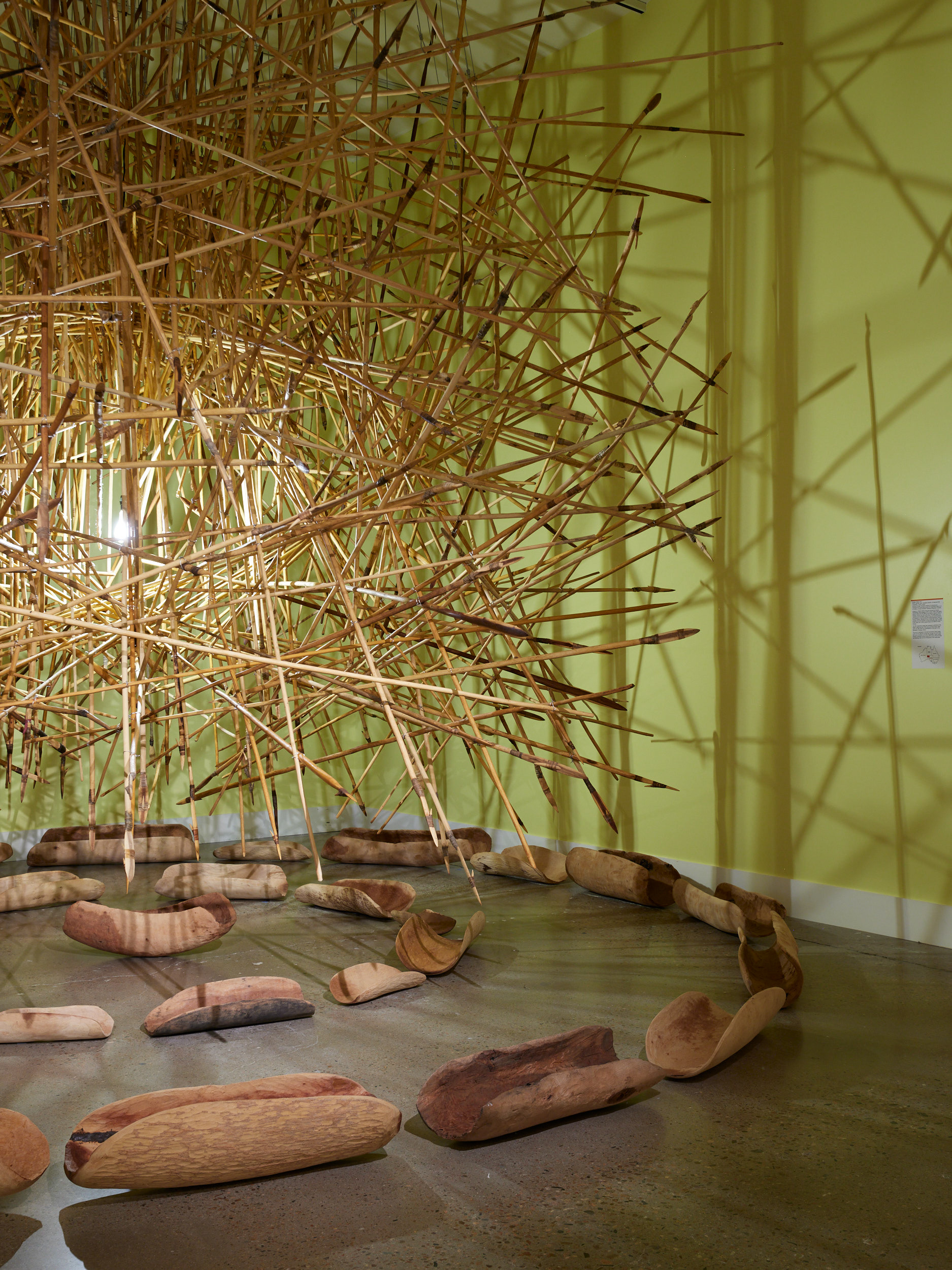 APY Art Collective. KULATA TJUTA, 2017. 550 suspended kulata (spears), 27 coolamons (wooden bowls), dimensions vary. Circumference work itself: 6-7M diameter. Image by Brad Trone
