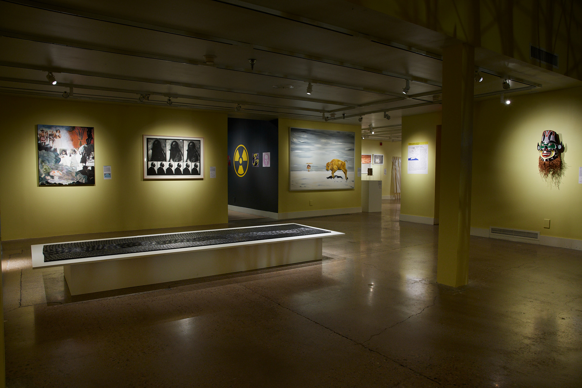 Main gallery. Left to right: Dan Talupapa, Te Mau Ata: Clouds, 2021. Carl Beam, Sitting Bull and Einstein (From the Series: The Columbus Suite) ca. 1990. Left to right: Adrian Simson, Fuse 3 (Series of 3 Paintings), 2010. David Neel, Cherenobyl Mask, 1993. Image by Brad Trone