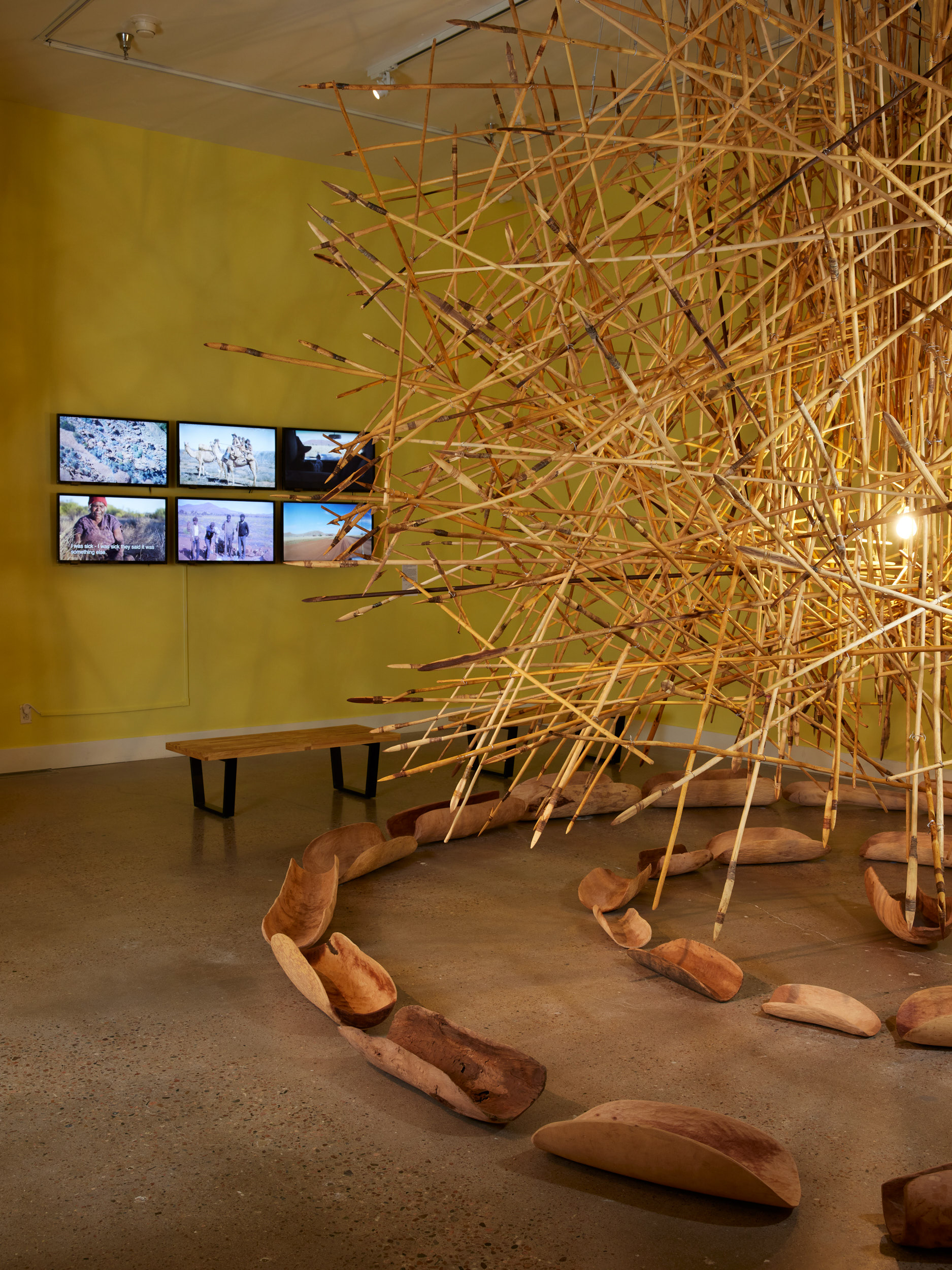 APY Art Collective. KULATA TJUTA, 2017. 550 suspended kulata (spears), 27 coolamons (wooden bowls), dimensions vary. Circumference work itself: 6-7M diameter. Image by Brad Trone