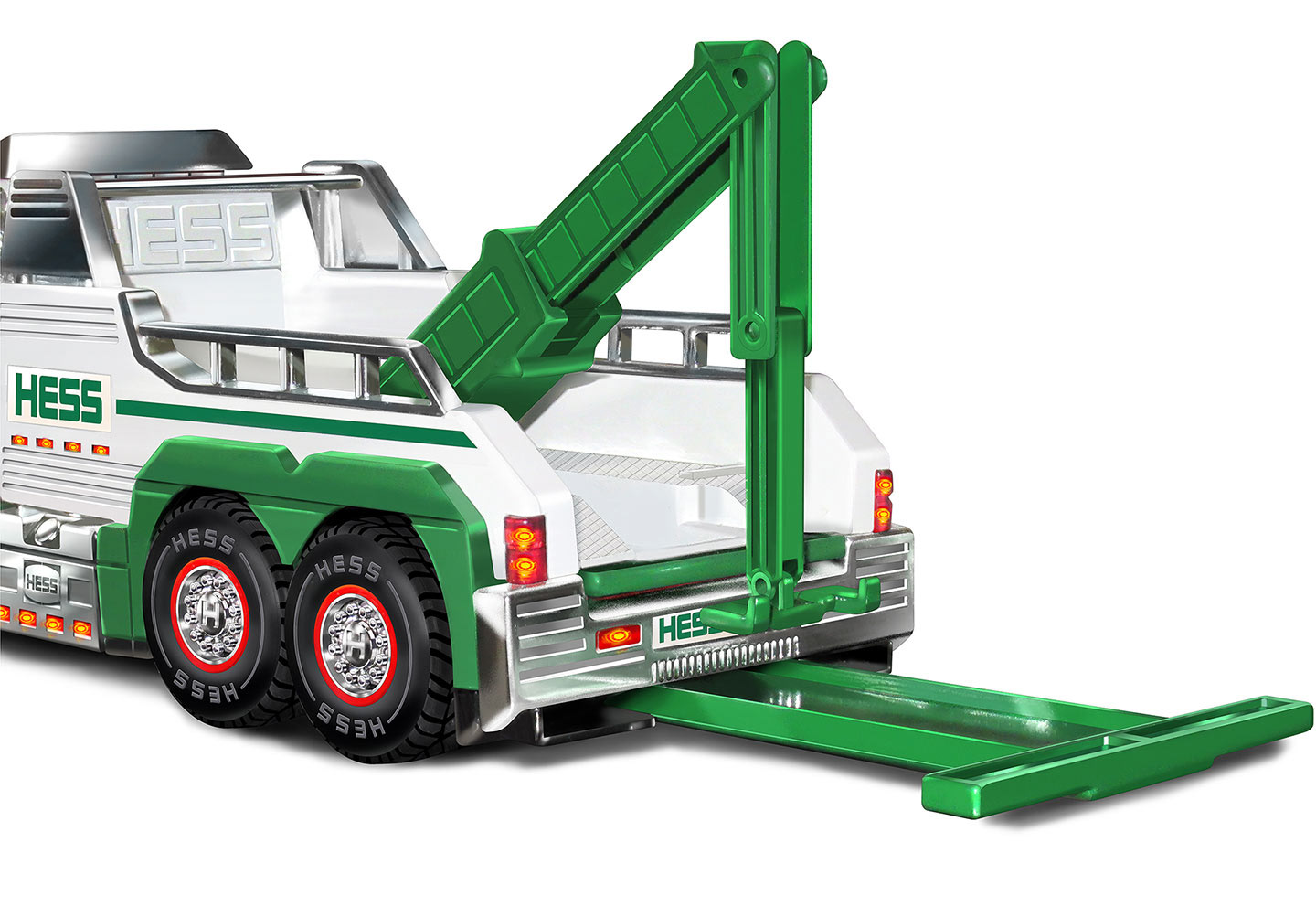 Hess toy truck rear 3/4 view, packaging illustration spot.
