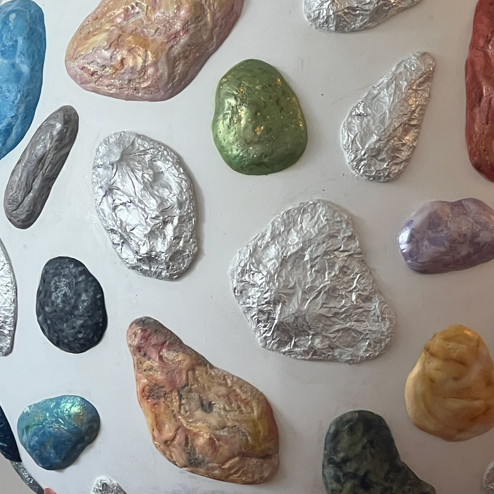 Gold flakes and metallic pigments were used to create different surface variations.