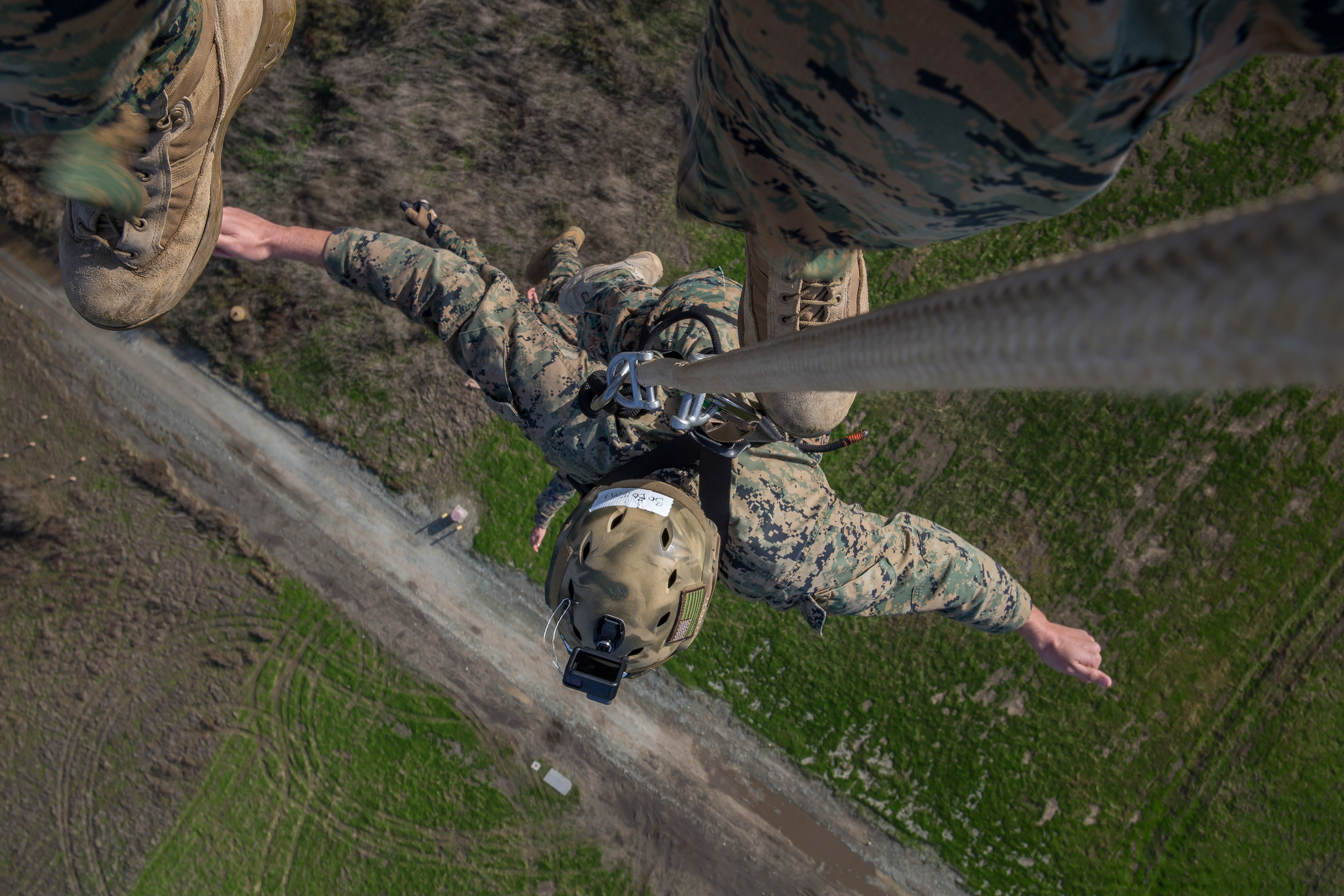 U.S. Marine Corps Warrant Officer Douglas Bobo, a cyber operations officer with 1st Radio Battalion, I Marine Expeditionary Force Information Group, uses a special patrol insertion/extraction (SPIE) harness to be lifted off the ground during a helicopter rope suspension technician (HRST) masters course at Marine Corps Base Camp Pendleton, California, Dec. 11, 2019. The course provided the students the ability to conduct HRST techniques safely on their own, including SPIE rigging, fast roping, and rappelling from helicopters, enabling their units to be able to insert and extract anywhere, even when a landing zone is unavailable.