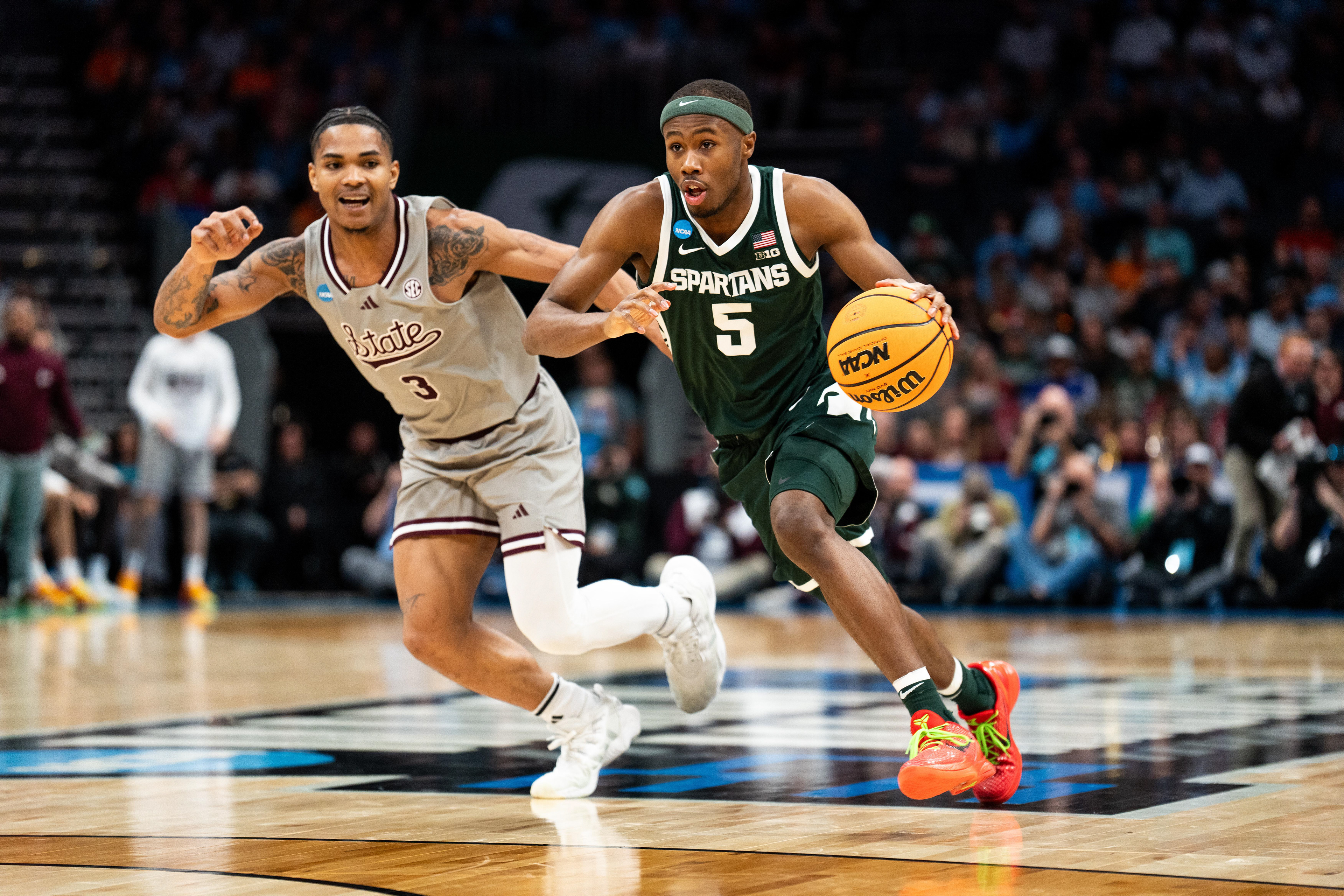 Michigan State sophomore guard No. 5 Tre Holloman drives the basket during round one of March Madness in Charlotte, North Carolina on March 21, 2024. The Spartans dominated the Mississippi State Bulldogs, maintaining a lead throughout the entire game, with a final score of 69-51.