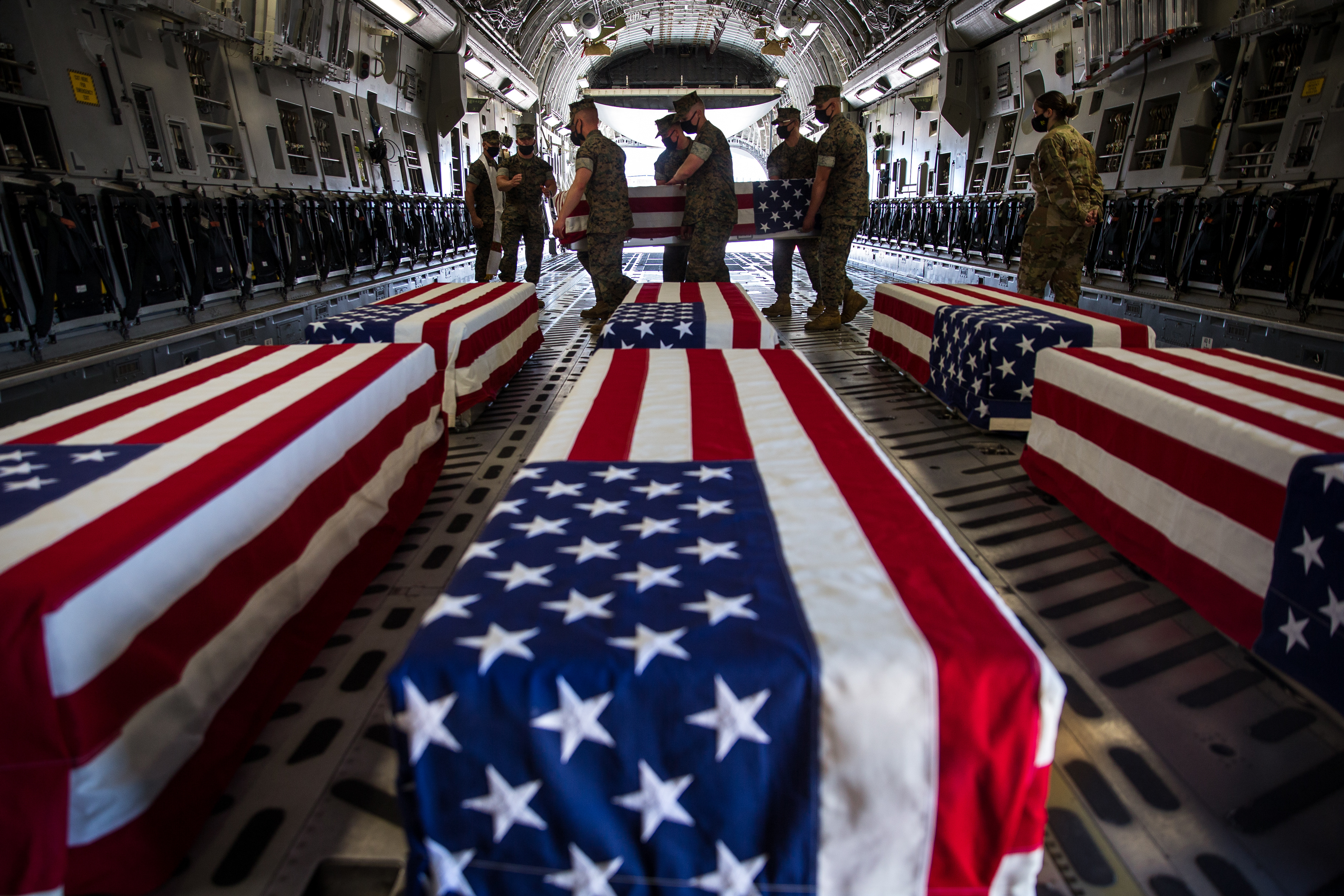 U.S. Marines and Sailors with Bravo Company, Battalion Landing Team 1/4, 15th Marine Expeditionary Unit, carry a casket inside a U.S. Air Force C-17 Globemaster III at Marine Corps Air Station Miramar, California, Aug. 12, 2020. The remains of seven Marines and a Sailor recovered Aug. 7 off the coast of San Clemente Island following a July 30 assault amphibious vehicle mishap were transferred to Dover Air Force Base, Delaware, for final preparation for burial before being released to their families.