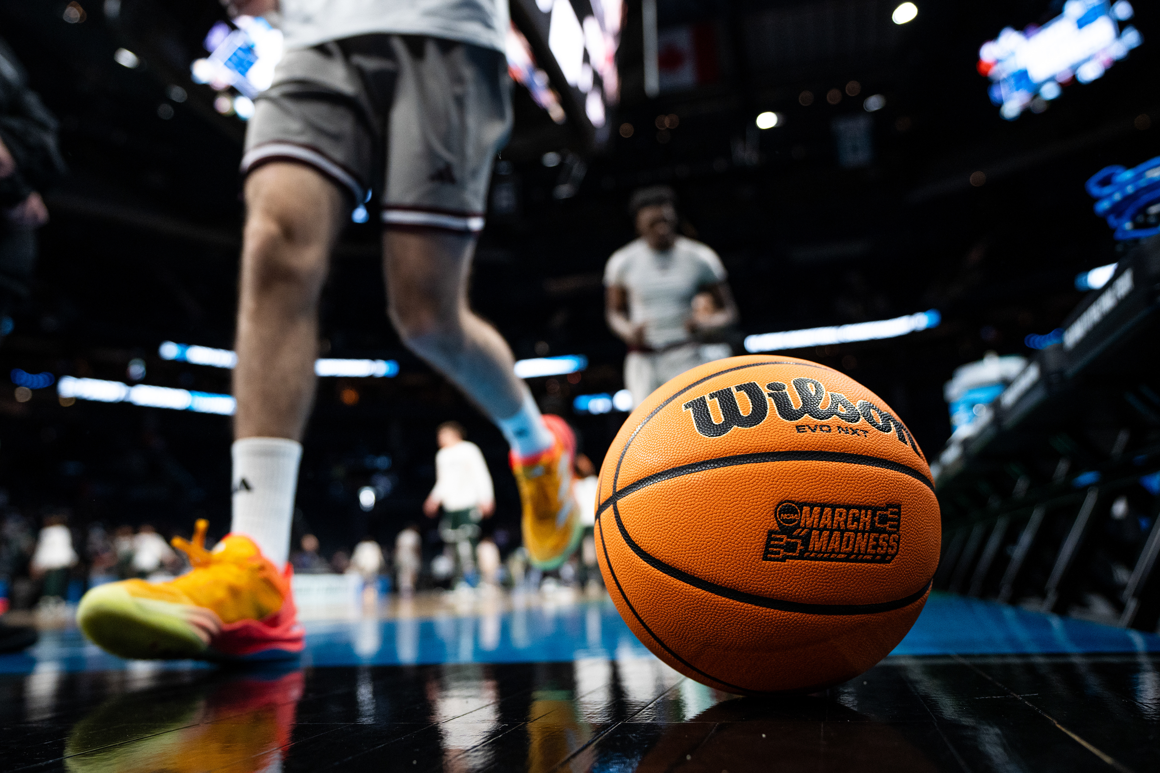Mississippi State players walk past an NCAA basketball prior to round one of March Madness in Charlotte, North Carolina on March 21, 2024. The Michigan State Spartans dominated the Bulldogs, maintaining a lead throughout the entire game, with a final score of 69-51.
