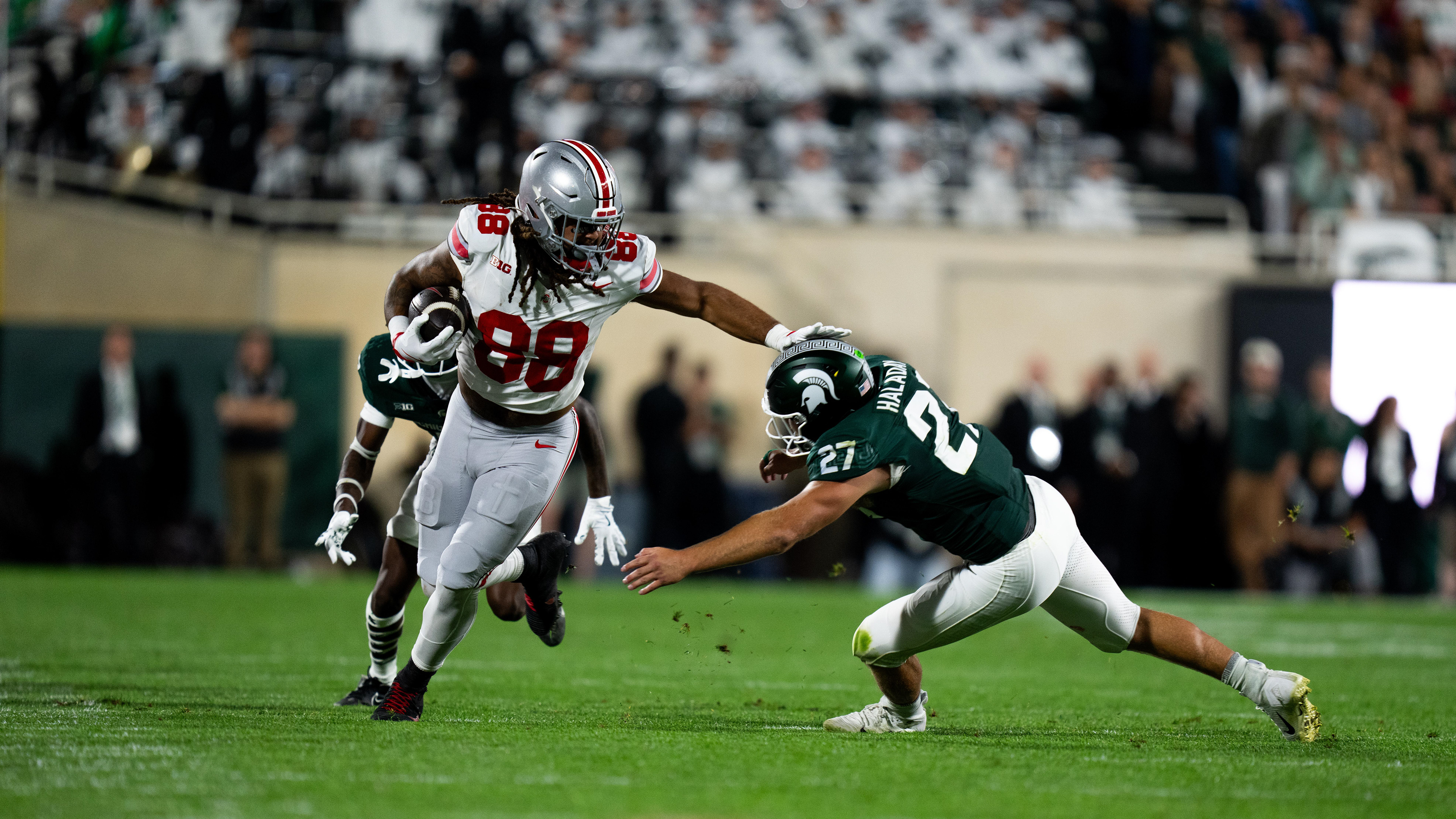 Ohio State graduate tight end (88) stiff arms Michigan State redshirt senior linebacker (27) Cal Haladay during the game against the Ohio State Buckeyes held in the Spartan Stadium on Sept. 29, 2024. Despite a competitive first half, the Spartans fell 38-7 to the Buckeyes.