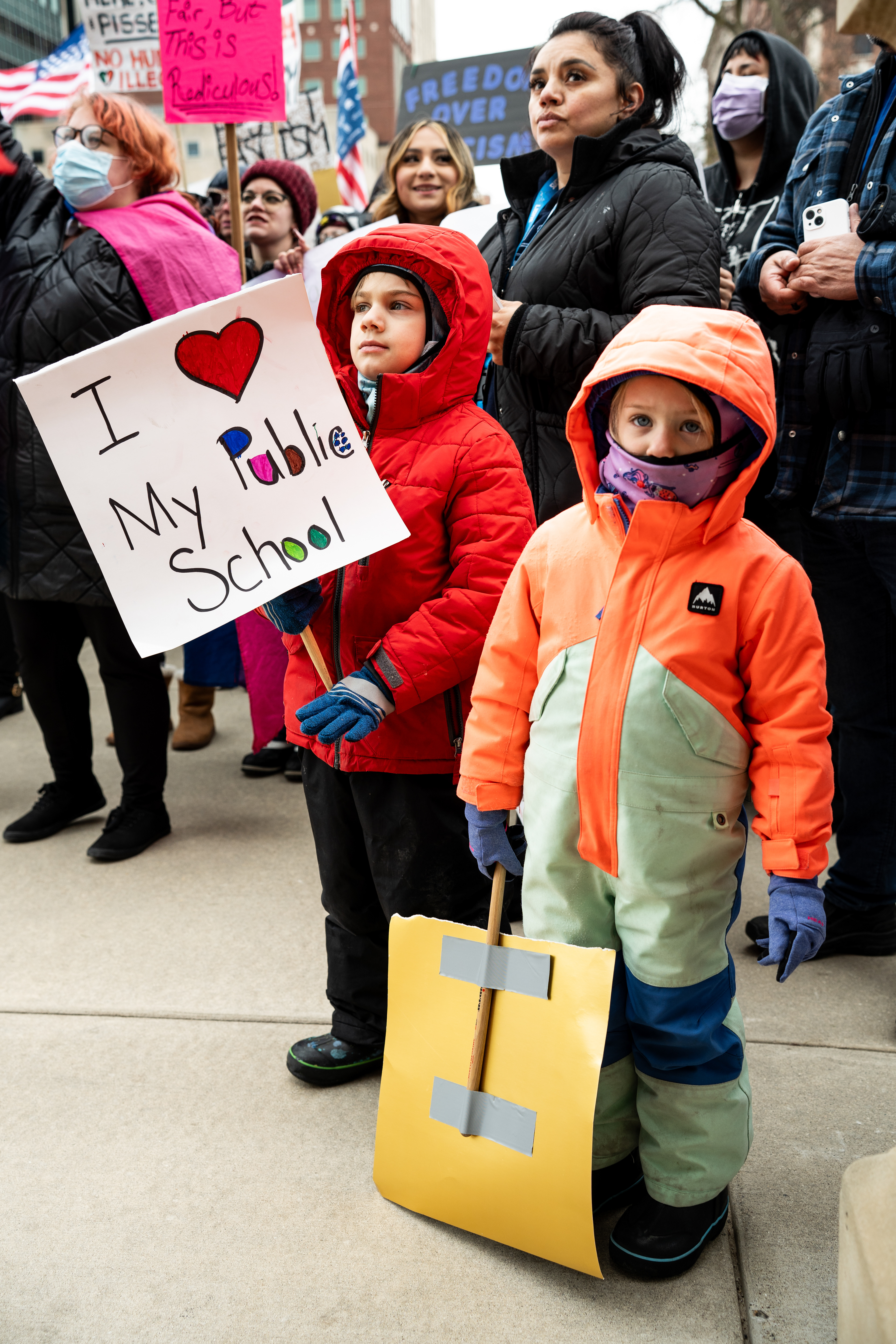 Kids hold signs at a protest at the Michigan Capitol Building in Lansing, Michigan on Feb. 5, 2025. Protesters gathered at the Michigan Capitol Building to demonstrate against President Donald Trump's cascade of executive orders.