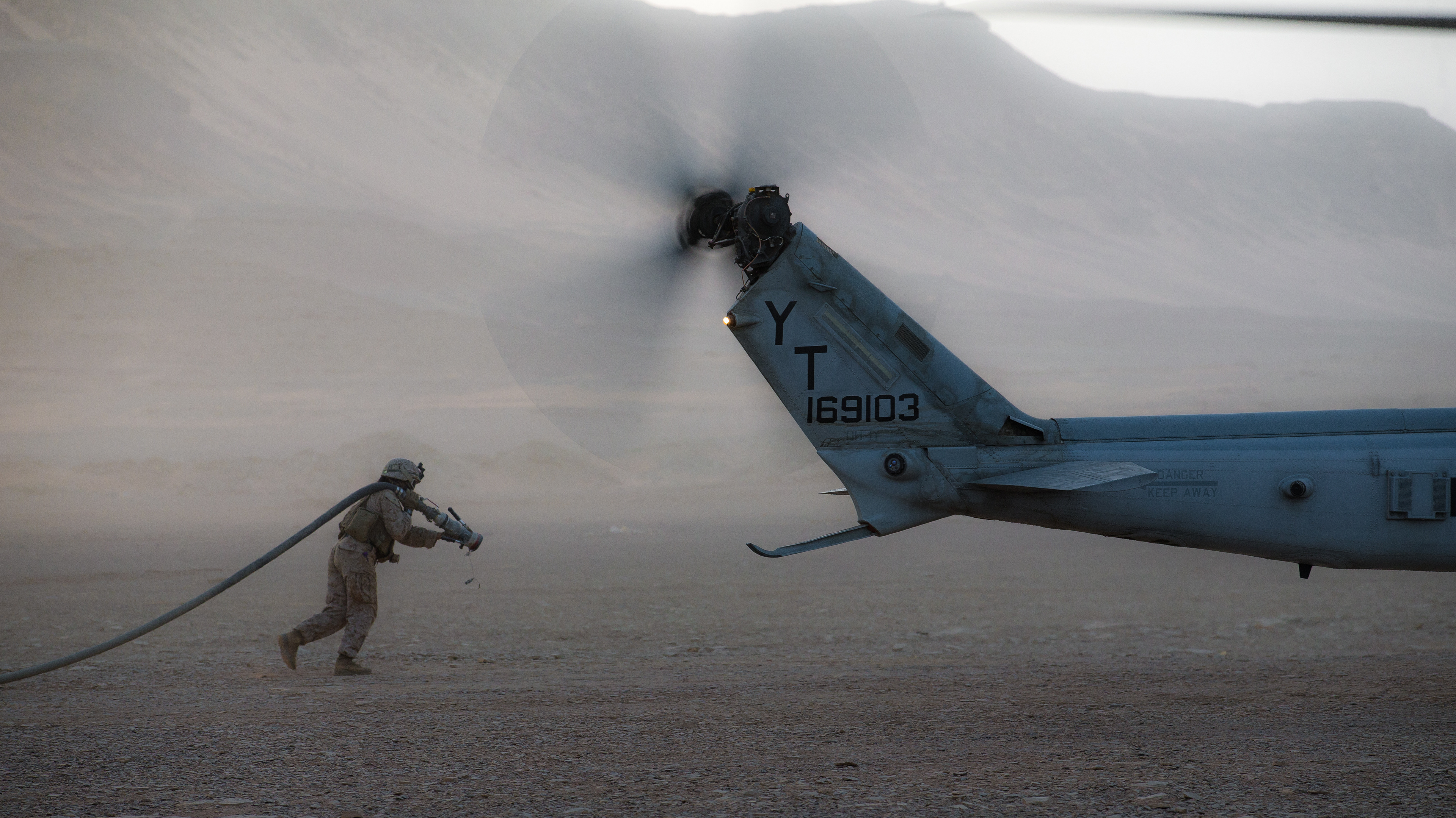 TABUK, Kingdom of Saudi Arabia (March 9, 2021) – U.S. Marine Corps Cpl. Selina Lopez, a radio operator assigned to Marine Medium Tiltrotor Squadron 164 (Reinforced), 15th Marine Expeditionary Unit (MEU), carries a fuel hose to a UH-1Y Venom at a forward arming and refueling point during a theater amphibious combat rehearsal (TACR) in Tabuk, Kingdom of Saudi Arabia, March 9. TACR integrates U.S. Navy and Marine Corps assets to practice and rehearse a range of critical combat-related capabilities available to U.S. Central Command, both afloat and ashore, to promote stability and security in the region. The 15th MEU is deployed to the U.S. 5th Fleet area of operations in support of naval operations to ensure maritime stability and security in the Central Region, connecting the Mediterranean and Pacific through the Western Indian Ocean and three strategic choke points.