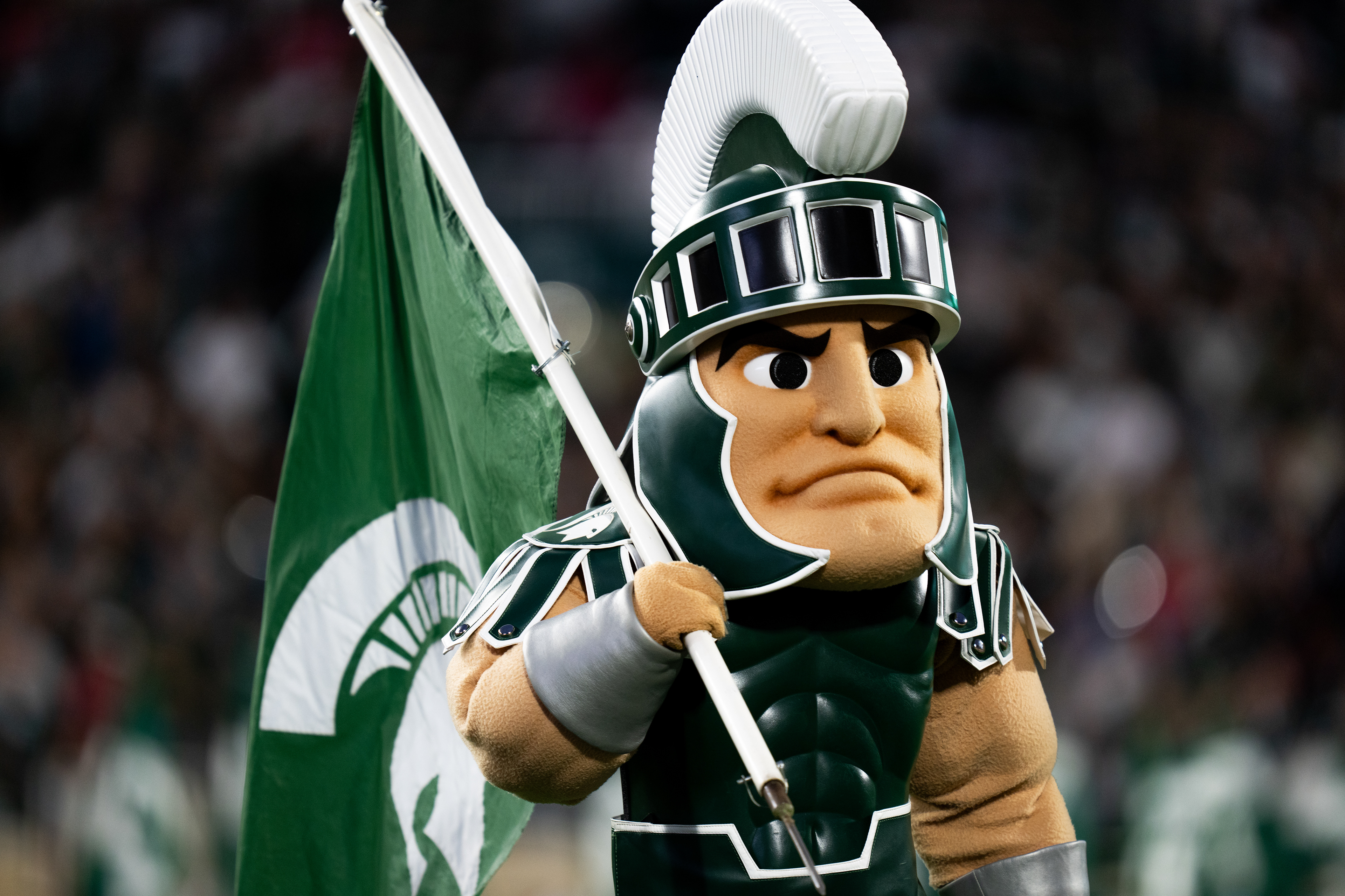 Sparty, the Michigan State University mascot carries an MSU flag prior to a football game against the Ohio State Buckeyes at Spartan Stadium on Sept. 28, 2024. Despite a competitive first half, the Spartans fell 38-7 to the Buckeyes.