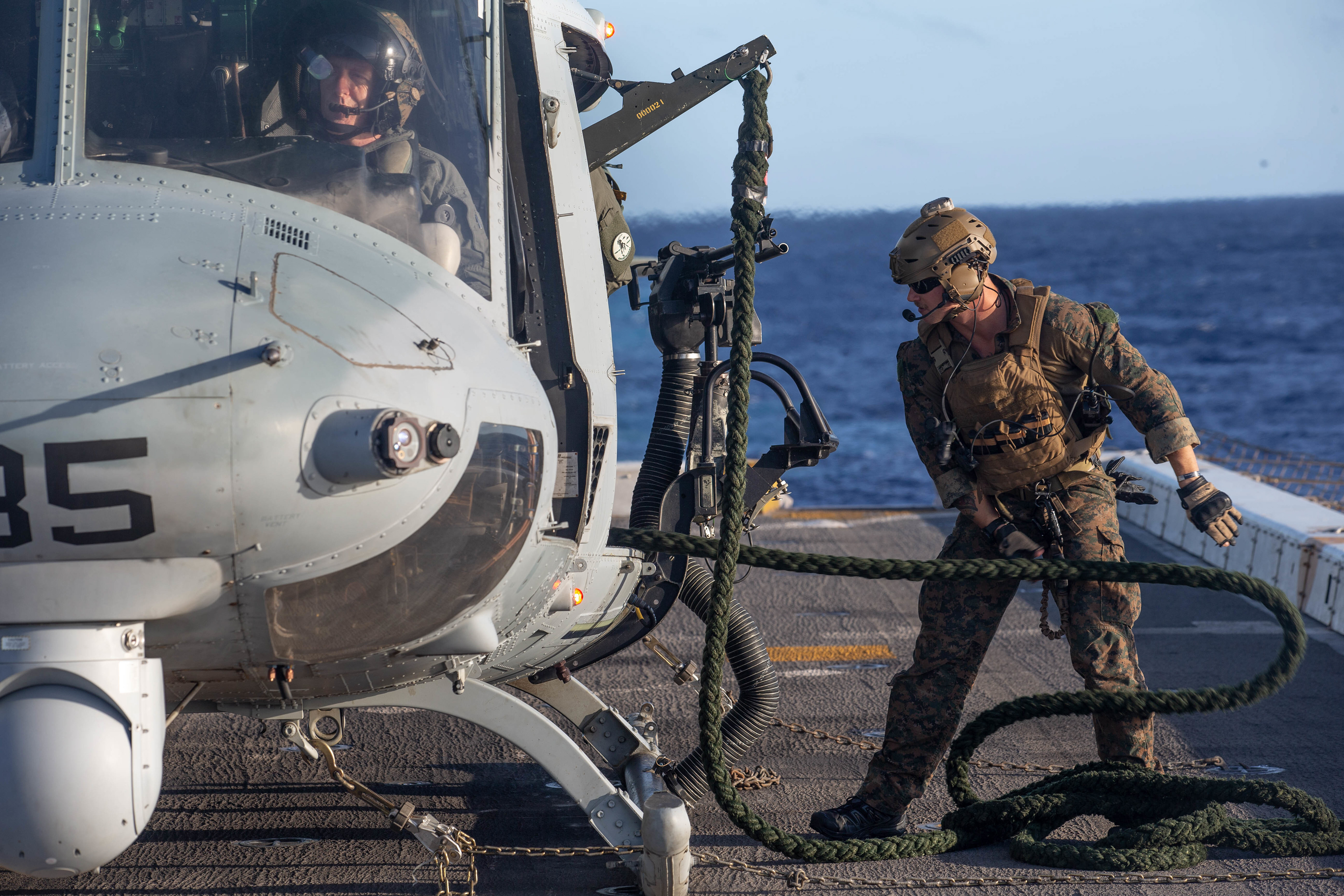 A U.S. Marine with the All-Domain Reconnaissance Detachment, 15th Marine Expeditionary Unit, prepares a rope for fast-rope training from a UH-1Y Venom with Marine Medium Tiltrotor Squadron 164 (Reinforced), 15th MEU, on the flight deck of the amphibious transport dock ship USS Somerset (LPD 25) in the Pacific Ocean, Nov. 30, 2020. The Makin Island Amphibious Ready Group and 15th MEU provide numbered fleet and combatant commanders with a responsive, flexible and forward-deployed asset capable of maritime power projection, contingency operations and crisis response.