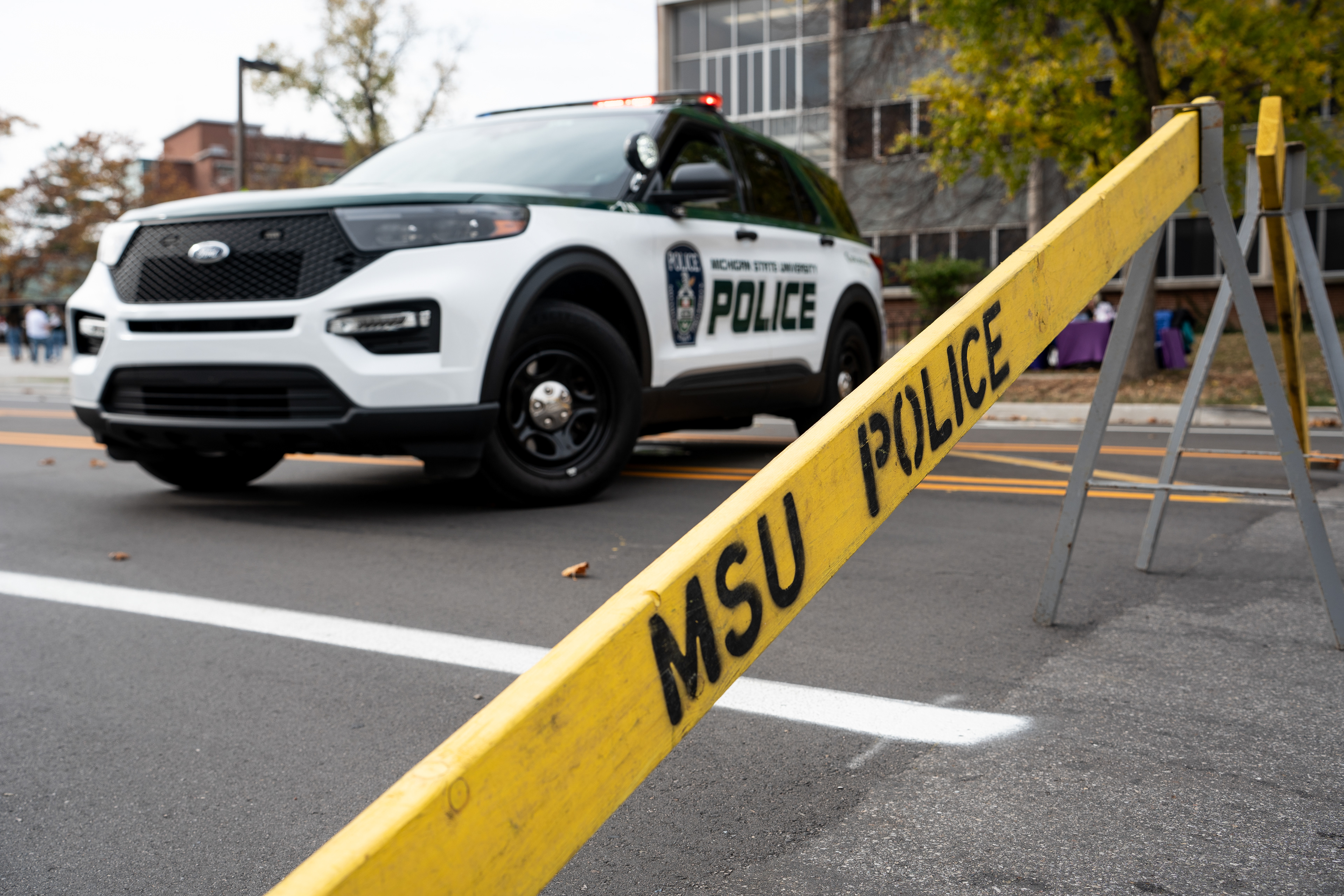 A Michigan State University Police patrol cruiser blocks off Farm Lane, north of the Red Cedar River on Oct. 29, 2024. Emergency services cordoned and evacuated the area surrounding the intersection of Farm Lane and N Shaw Lane.