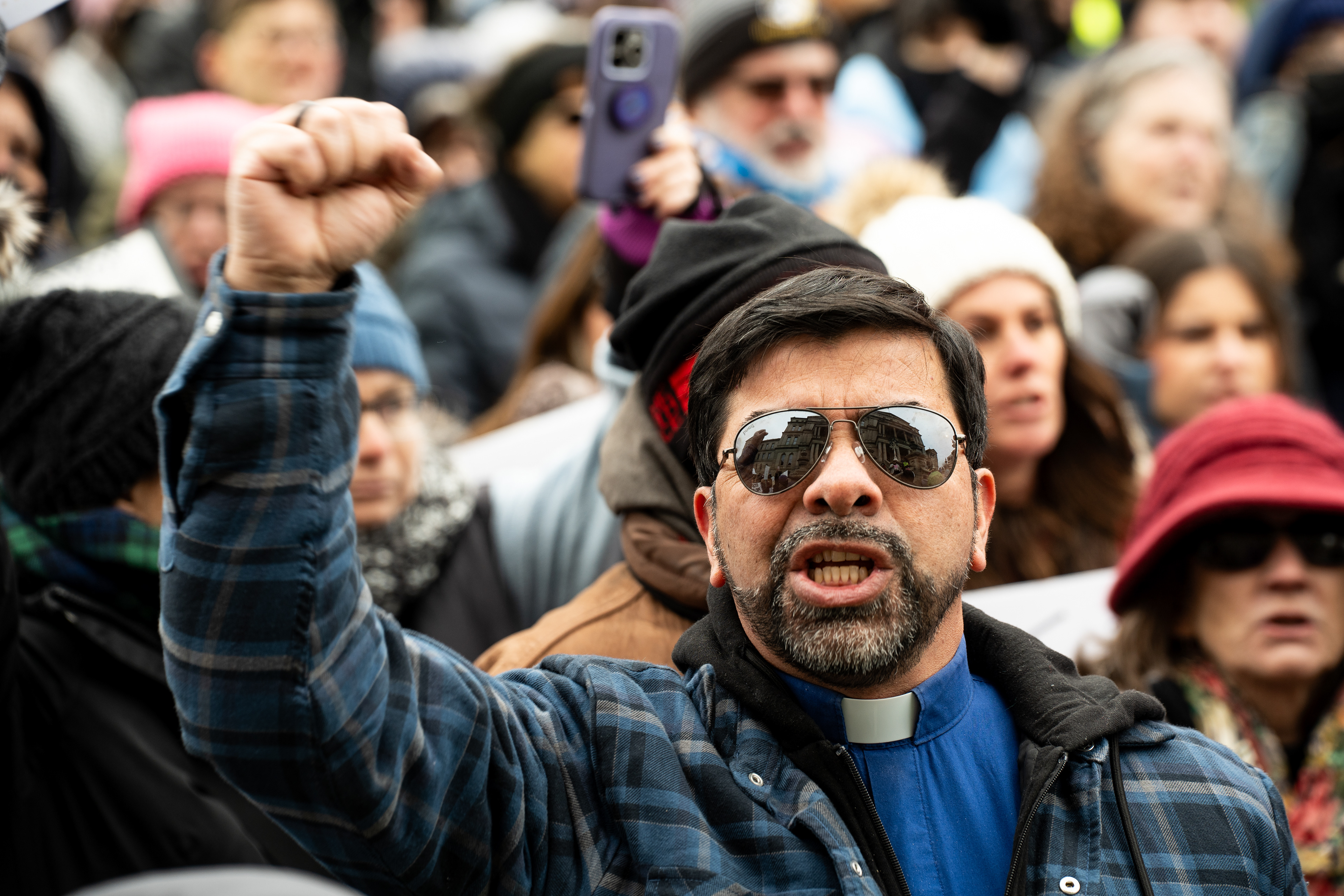 A protester shouts at the Michigan Capitol Building in Lansing, Michigan on Feb. 5, 2025. Protesters gathered at the Michigan Capitol Building to demonstrate against President Donald Trump's cascade of executive orders.