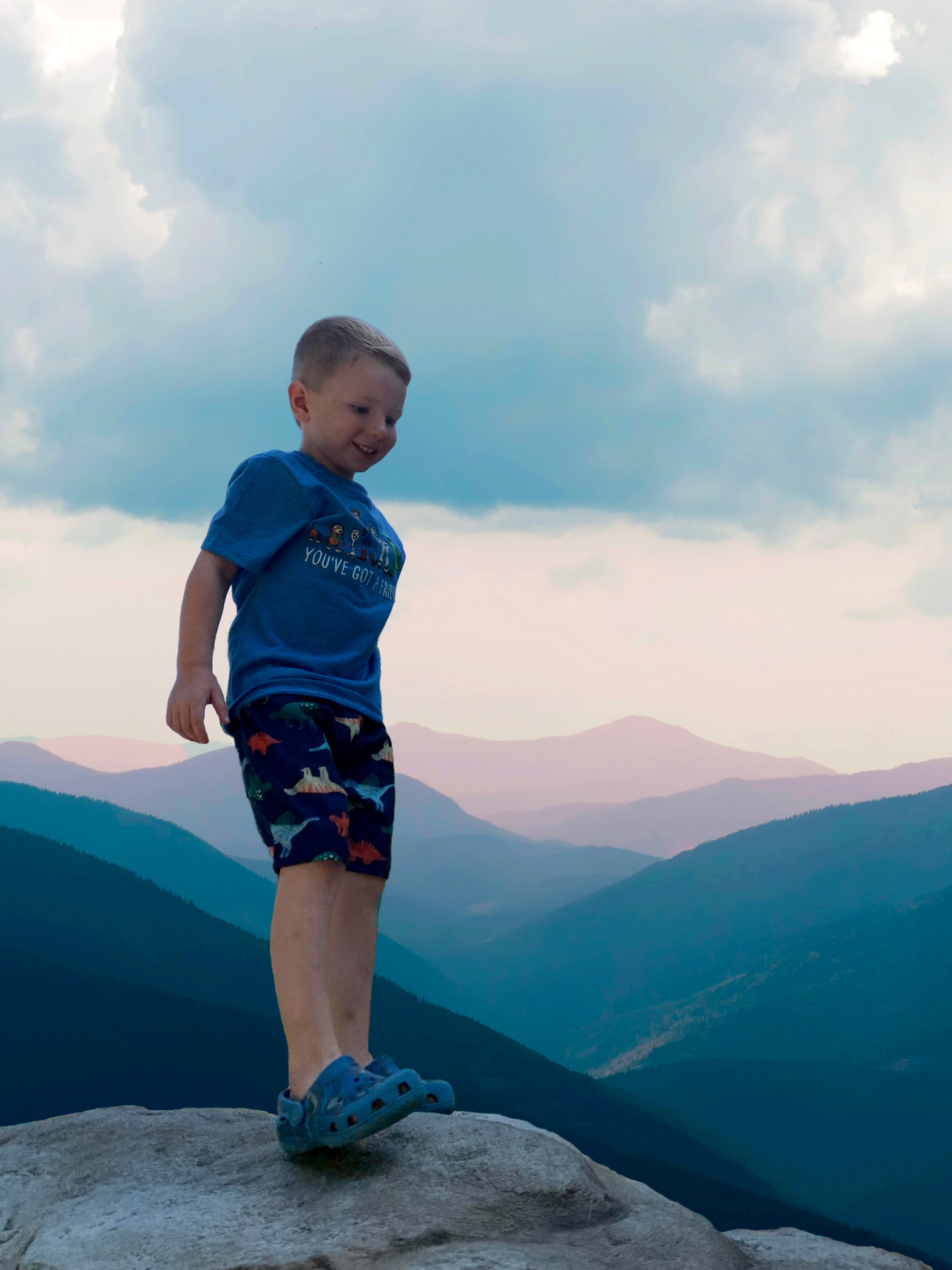 Image of boy photoshopped to make him look on a mountain