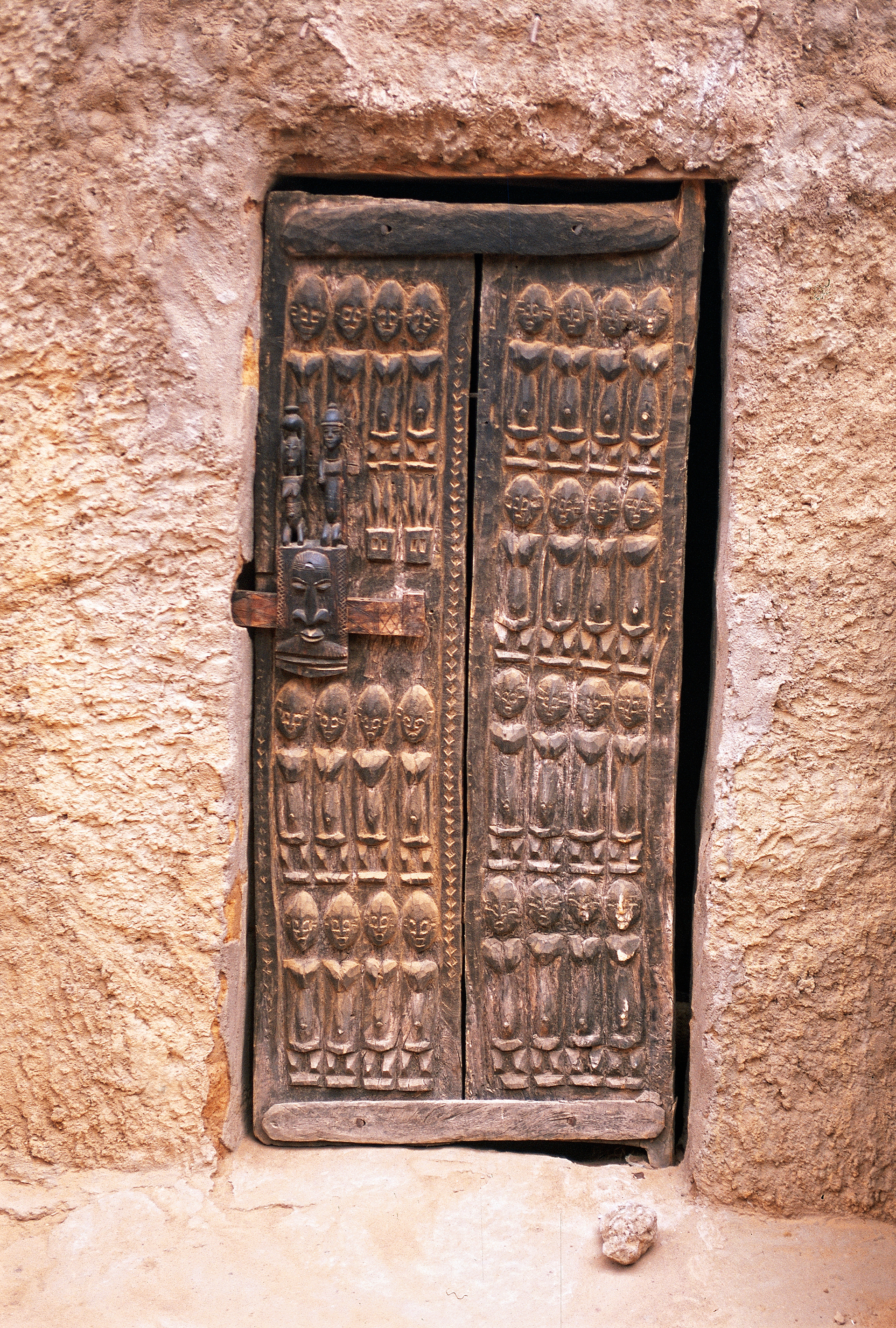 Wooden door At the Bandiagara cliffs in dogon country | Licensed istock precedence photograph credited to Bombaert