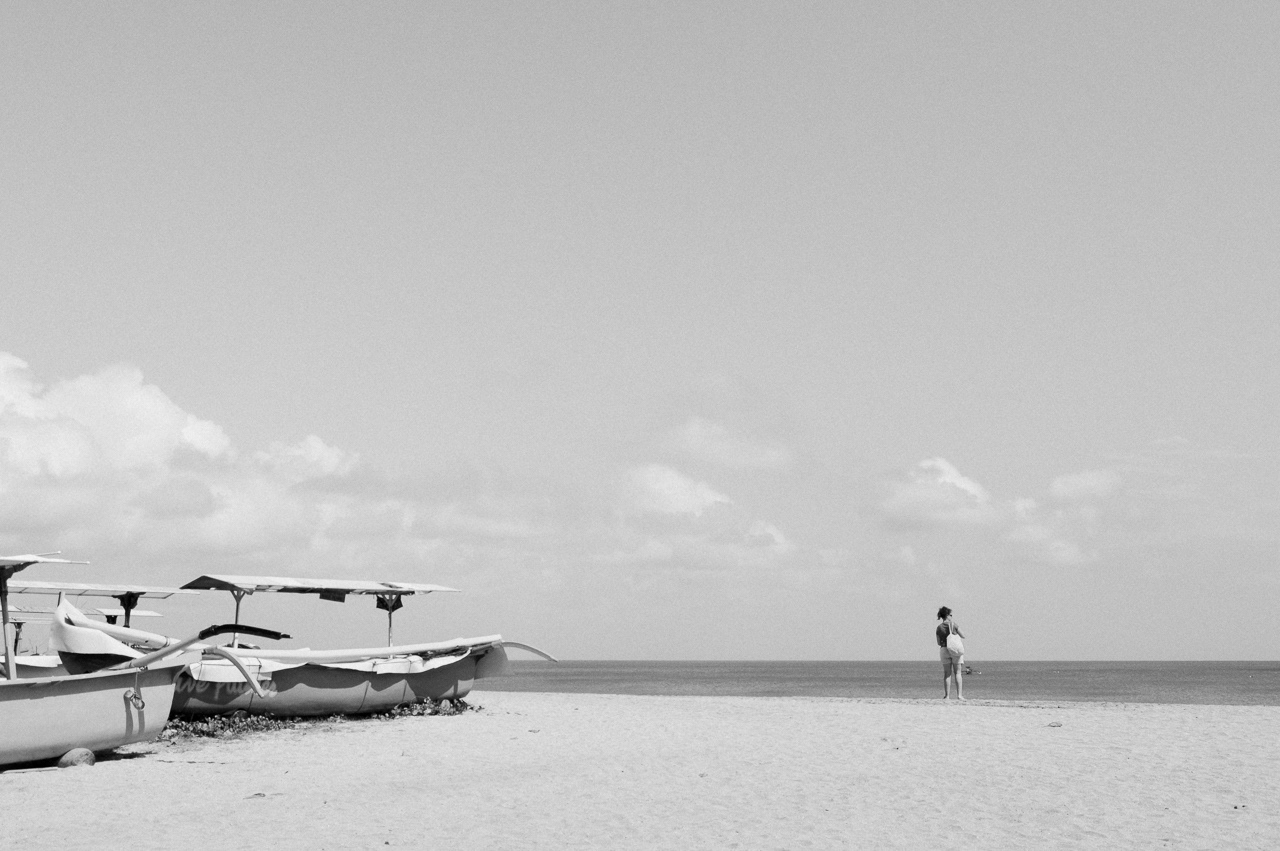 Woman standing by the shore. Kuta, 2014.