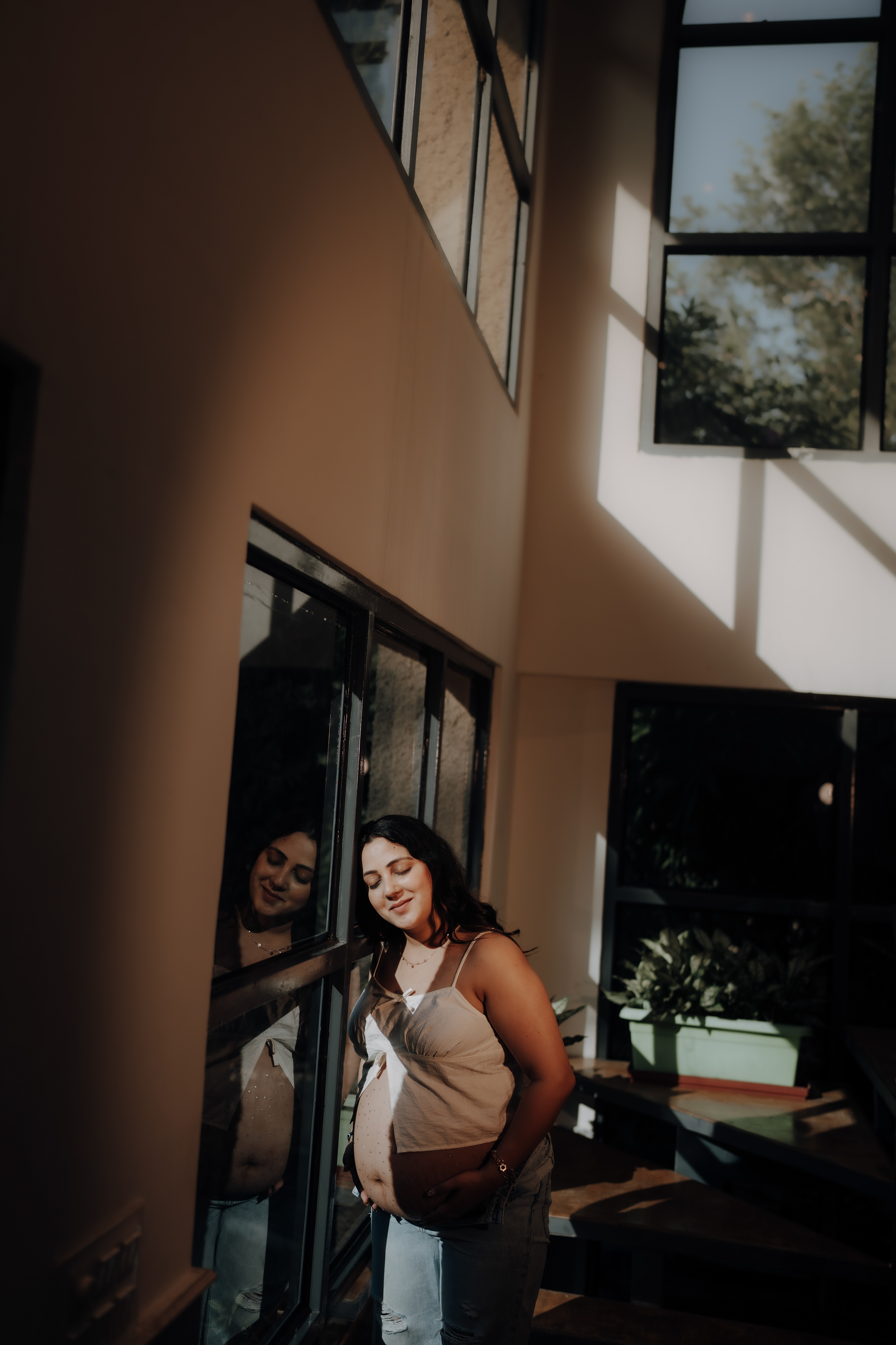 "Peacefully waiting by the window — a soft and soulful maternity frame at Aqua Vista by RP Films Jammu."