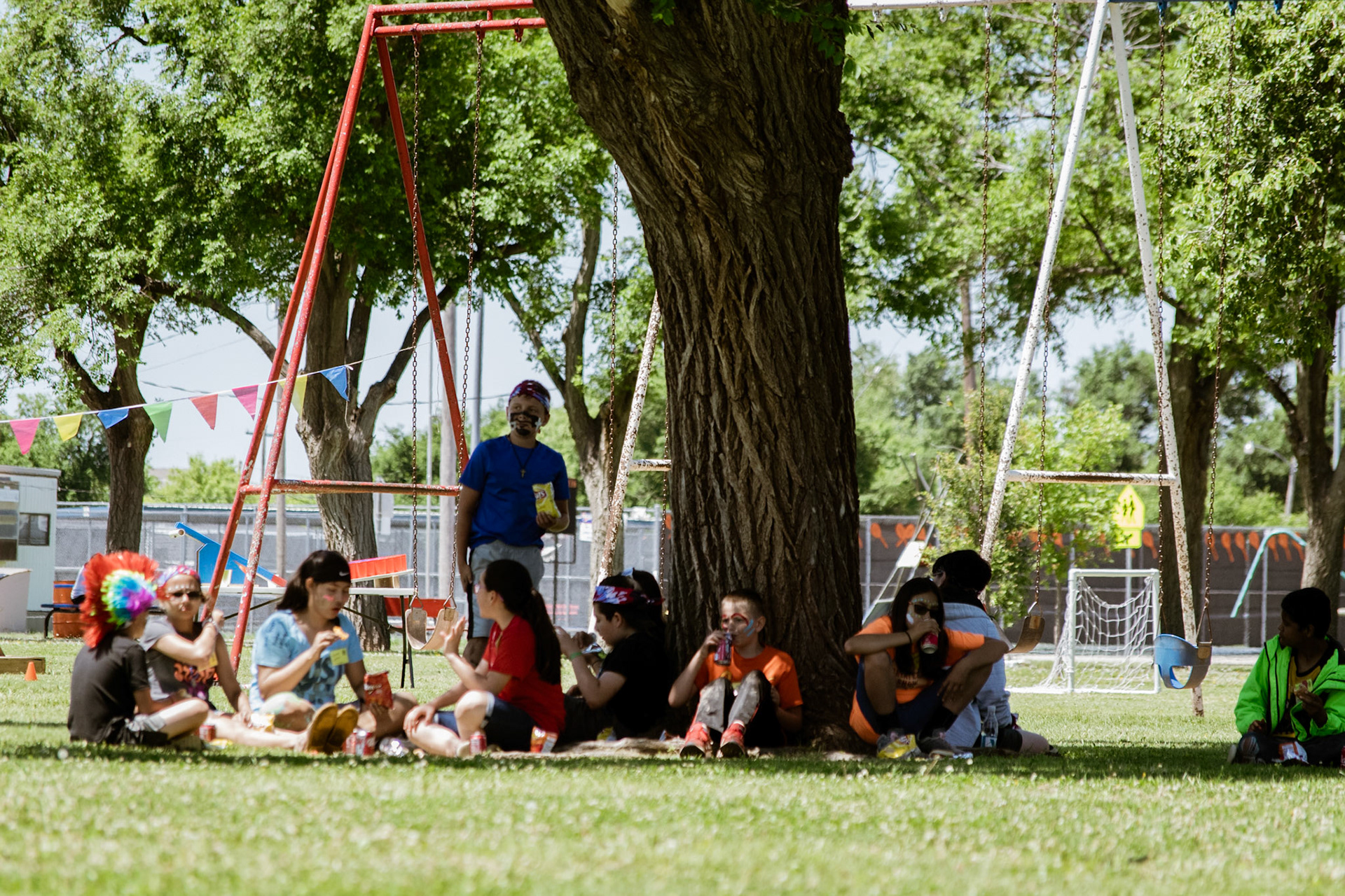 kids enjoying a summer camp meal outside