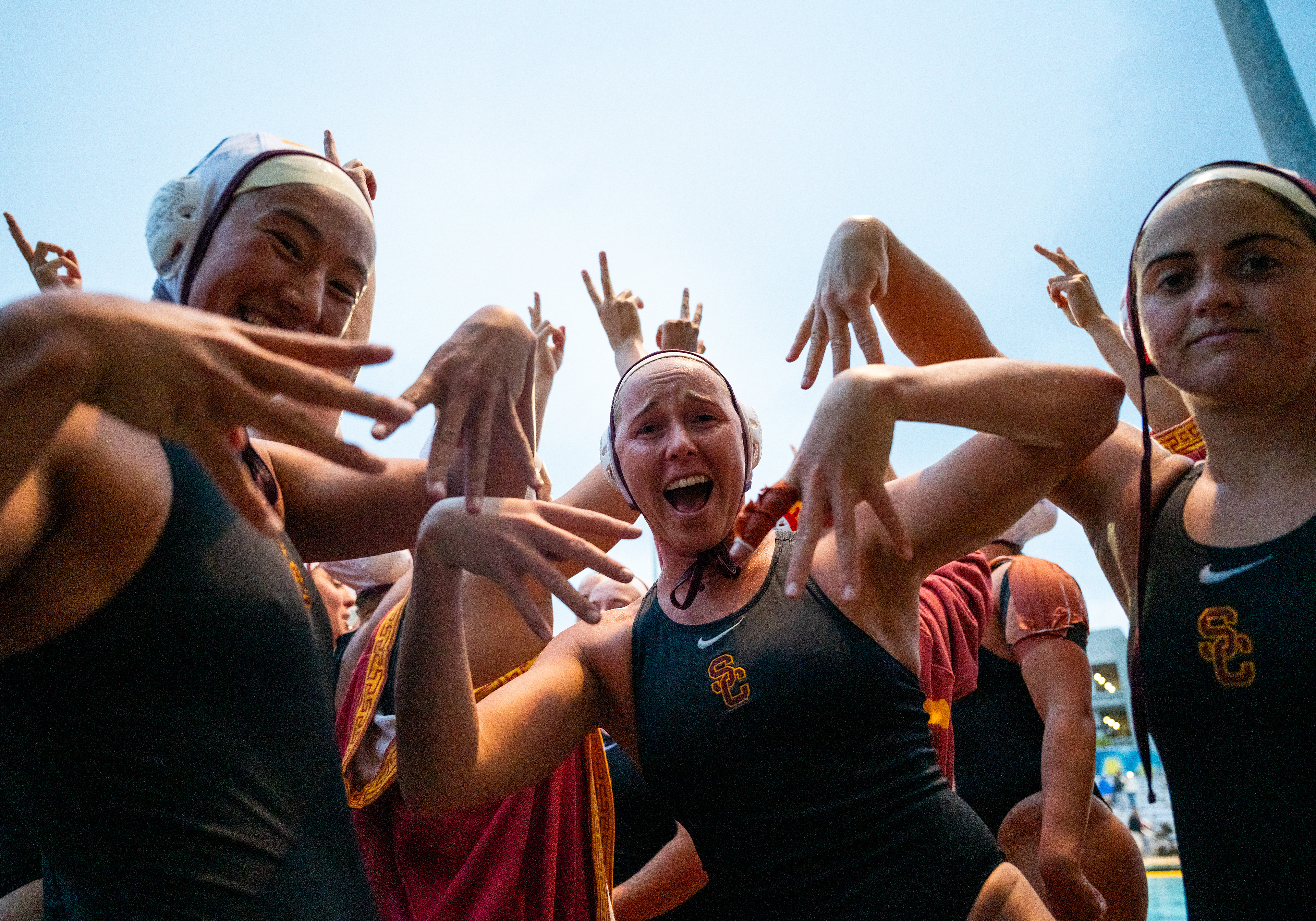 From left, Southern California attackers Emily Ausmus, Ava Stryker and goalie Anna Reed celebrate after defeating UCLA in an NCAA water polo championship semifinal in Saturday, April 25, 2026 in San Diego. (Vincent Leo/KLC fotos)