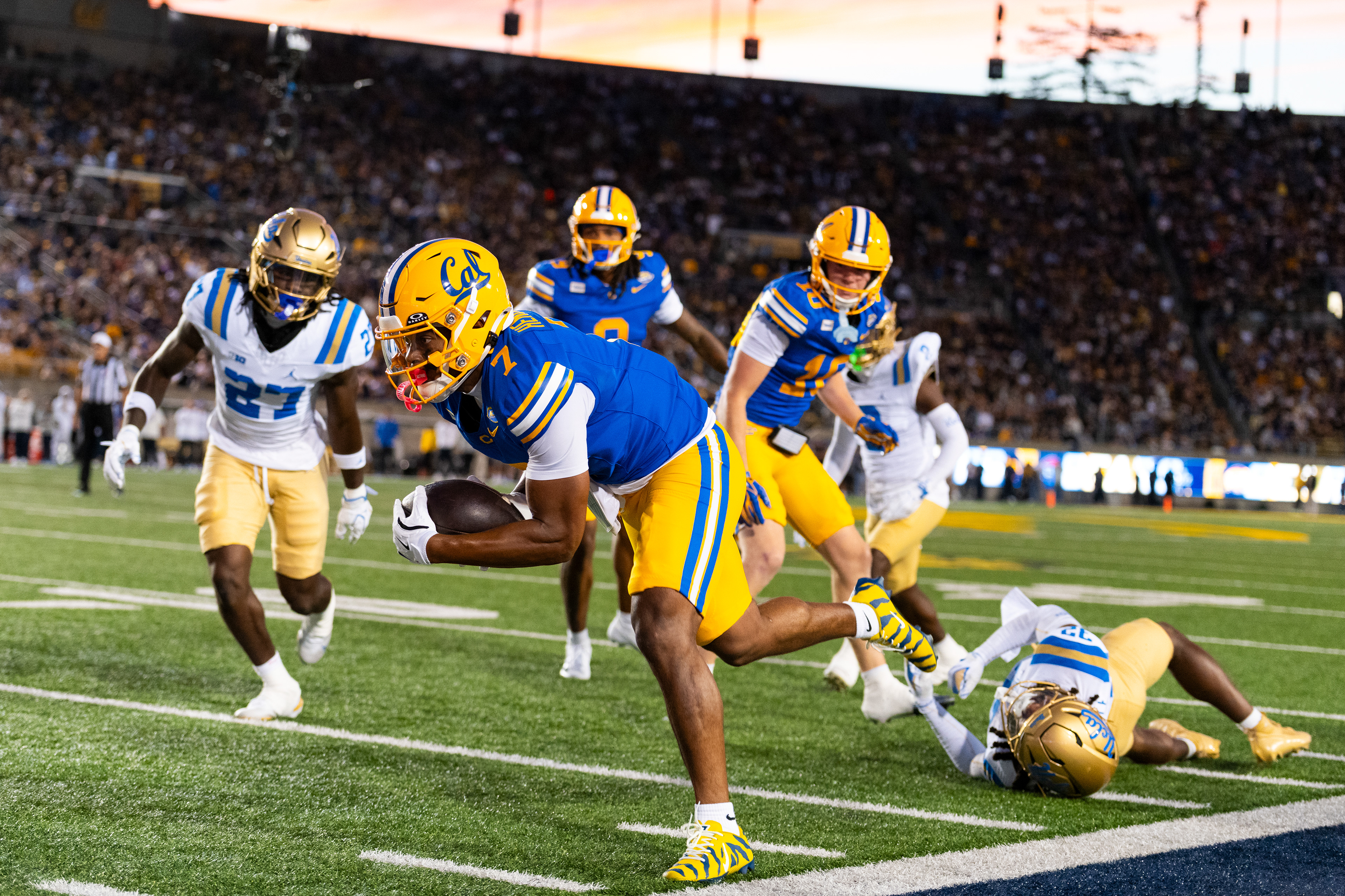California wide receiver Chase Hendricks (7) scores a touchdown while being defended by UCLA defensive back Derrick Barksdale, right, during the first half of an NCAA college football game Saturday, Sept. 5, 2026 in Berkeley, Calif. (Vincent Leo/KLC fotos)