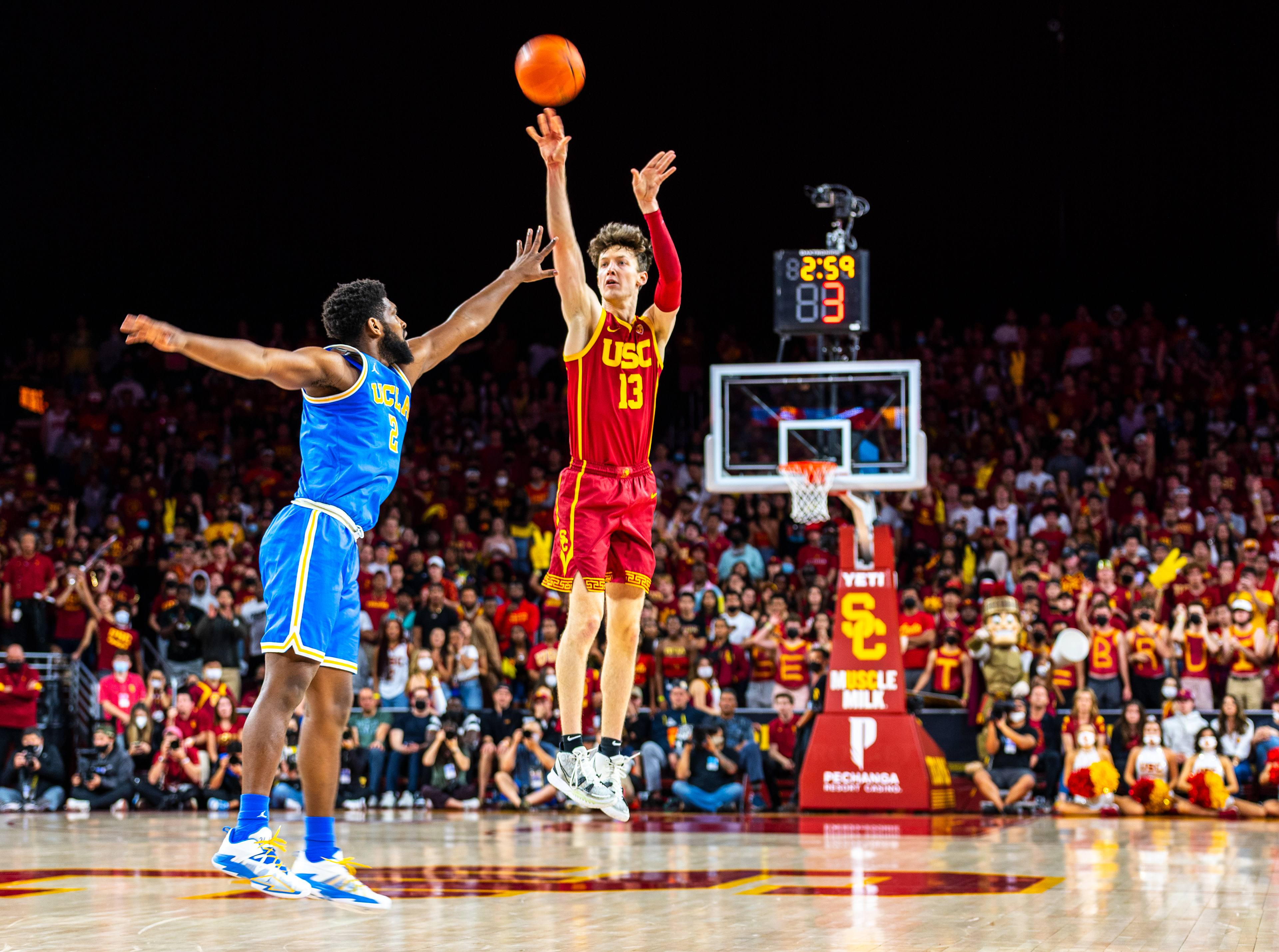 USC guard Drew Peterson (13) shoots a 3-pointer over UCLA forward Cody Riley (2) in the second half of the NCAA men’s college basketball game at the Galen Center in Los Angeles, California, on February 12, 2022. (Vincent Leo/Daily Trojan)