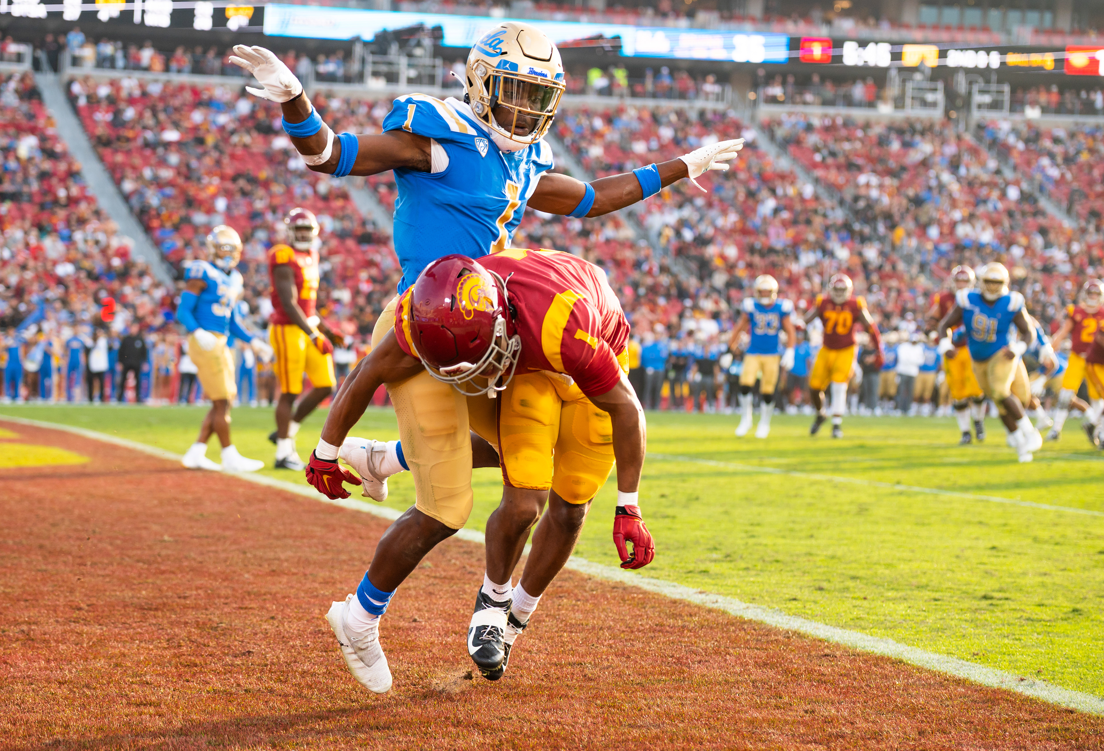 USC wide receiver Gary Bryant Jr. (1) begins to fall while being defended by UCLA defensive back Jay Shaw (1) in the second half of the NCAA college football game at Los Angeles Memorial Coliseum in Los Angeles, California, on November 20, 2021. (Vincent Leo/Daily Trojan)