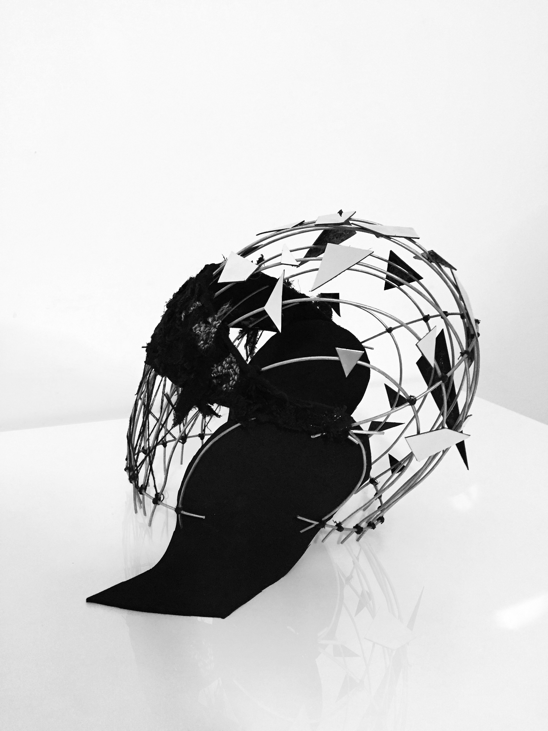 After a series of sketches that did not best represent the idea we had in mind, we found “our man”. Our mask is in itself a collection of references and meanings. The cage structure refers to feeling prisoners of a place that is not considered as ours. The sharp mirrors refer to the mask that everyone wears every day. We defined it as a mask that reflects and therefore represents how society wants us to be. Every once in a while this mask falls, and it shatters. We find ourselves alone and lost, and most of the time uncomfortable showing who we really are, afraid of being teased or not accepted. What remains is the shards of the mask that we used to protect ourselves before, hiding behind a face that is not ours. Now those sharp shards serve to protect us differently, stinging anyone who tries to hurt or harm us. Pushing people away at the first sight.