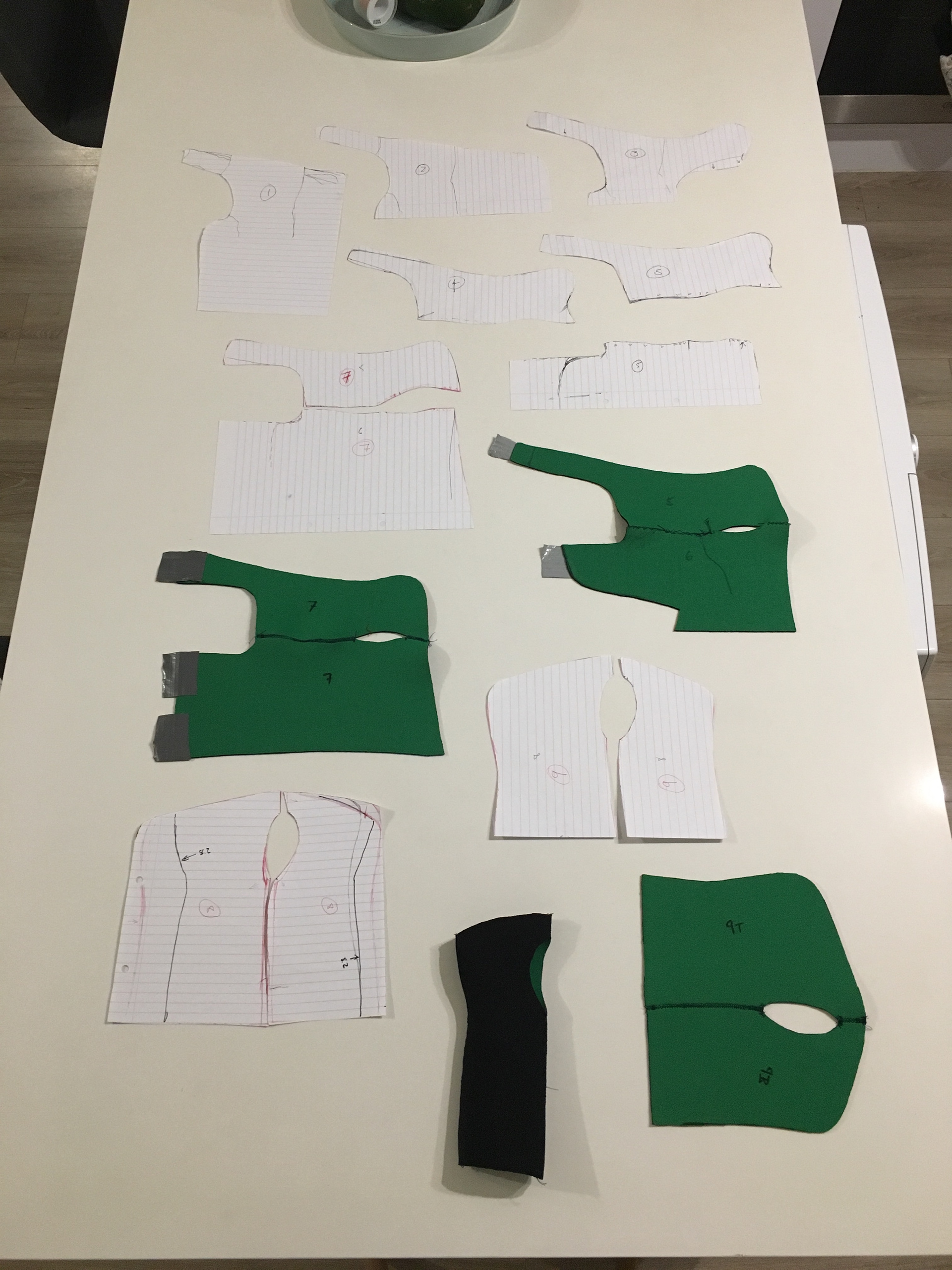 The first 8 prototypes on the kitchen counter. I'd considered using a zip on the bottom middle one...