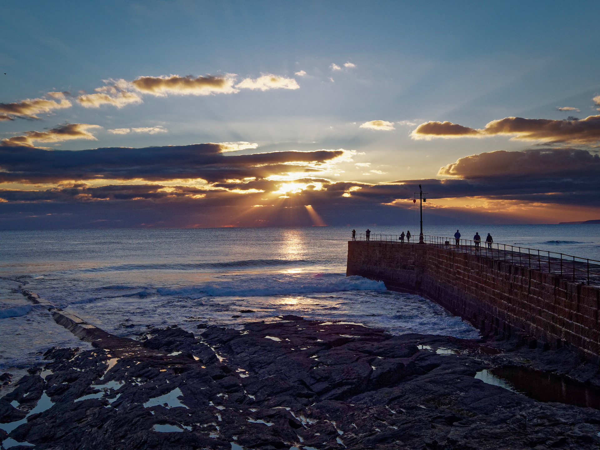 Outer harbour wall at Porthleven at sunset