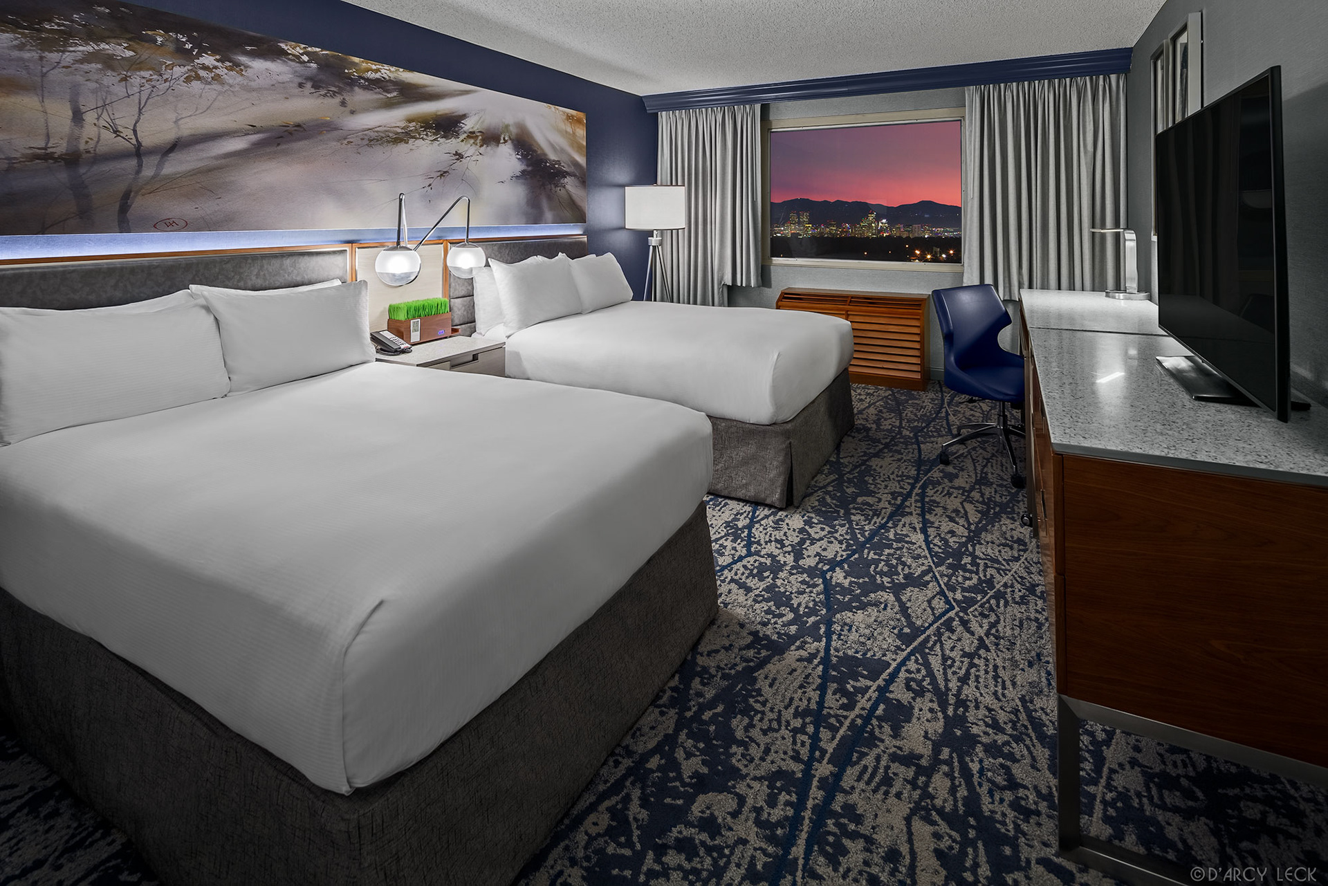 hotel photographer D'Arcy Leck photographs a guest room at the Doubletree Denver hotel