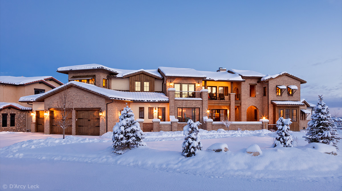 architectural photography of the exterior of a luxury residential home at dawn in winter after snowfall
