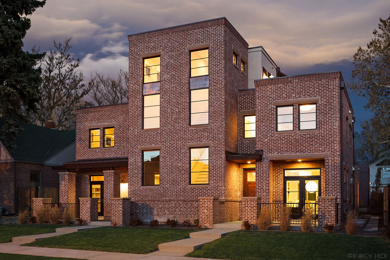 architectural photographer D'Arcy Leck photographs the exterior of an urban brick duplex at dusk
