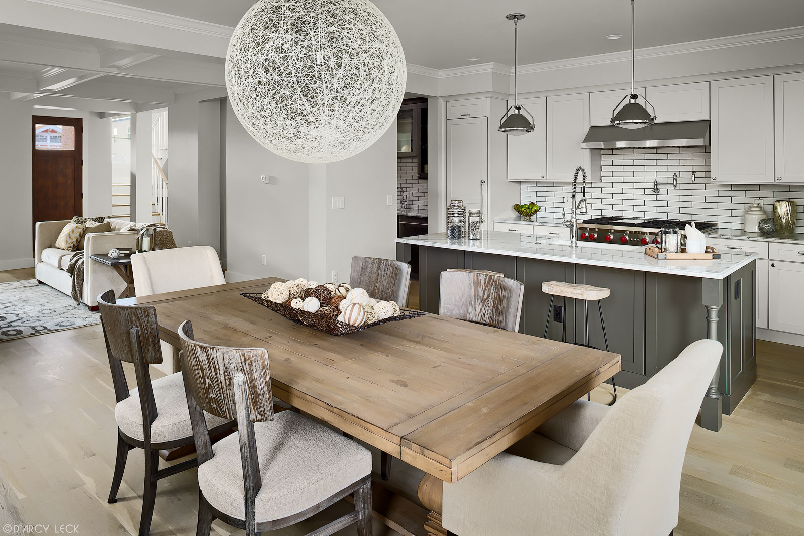 interior architectural photographer D'Arcy Leck photographs a dining room, kitchen, and living room of a modern urban duplex