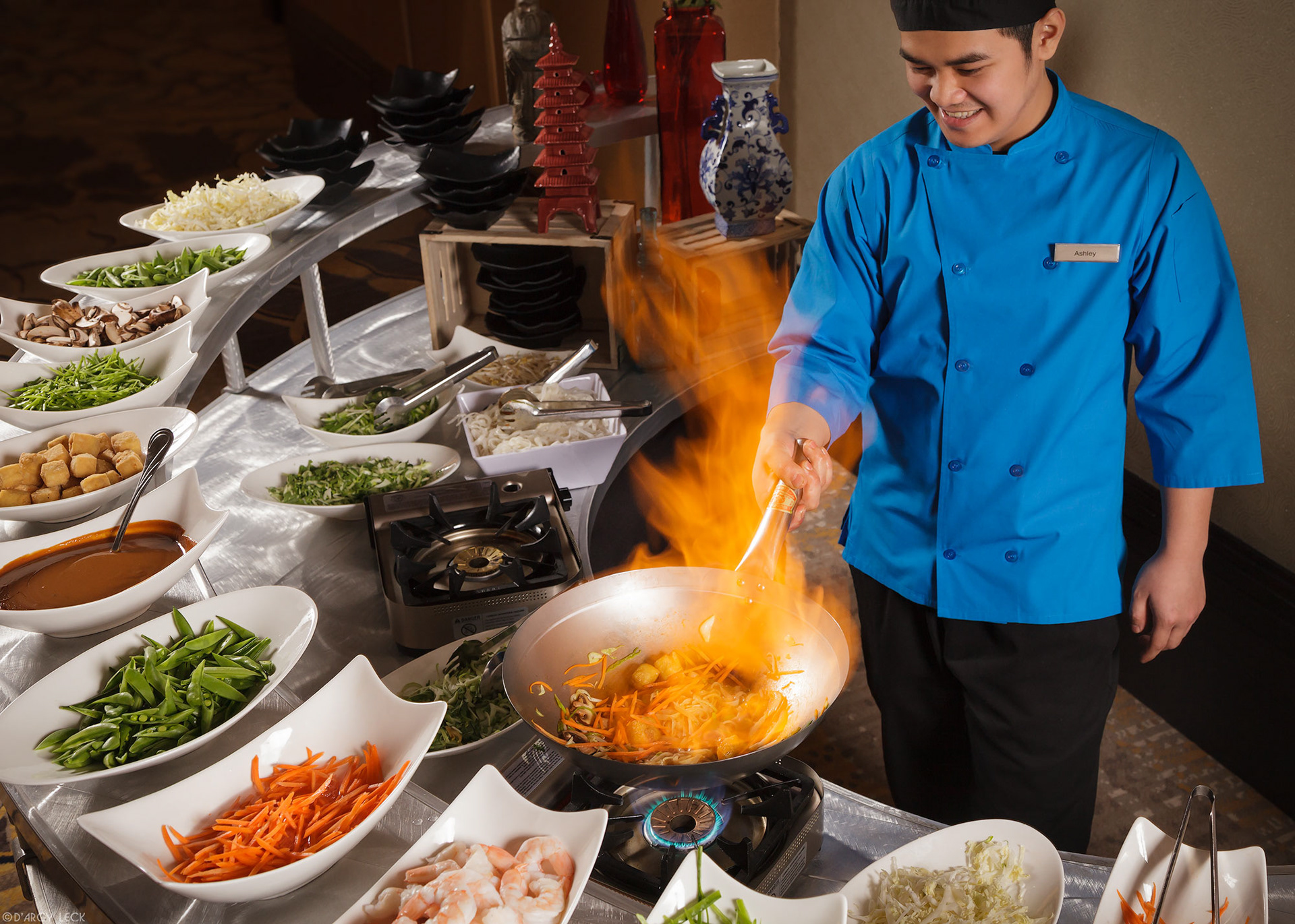 Hospitality photographer D'Arcy Leck captures restaurant server preparing stir fry at Hilton Granite Park hotel