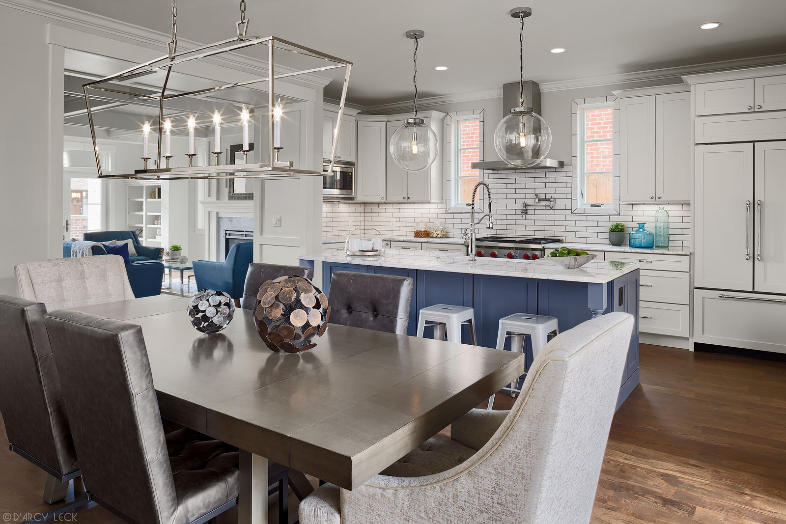 interior architectural photographer D'Arcy Leck photographs a dining room, kitchen, and living room of a modern duplex 