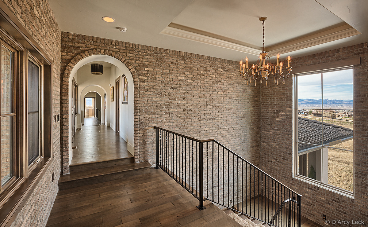 architectural photographer D'Arcy Leck photographs the upper stairway and hallway of a luxury residential home
