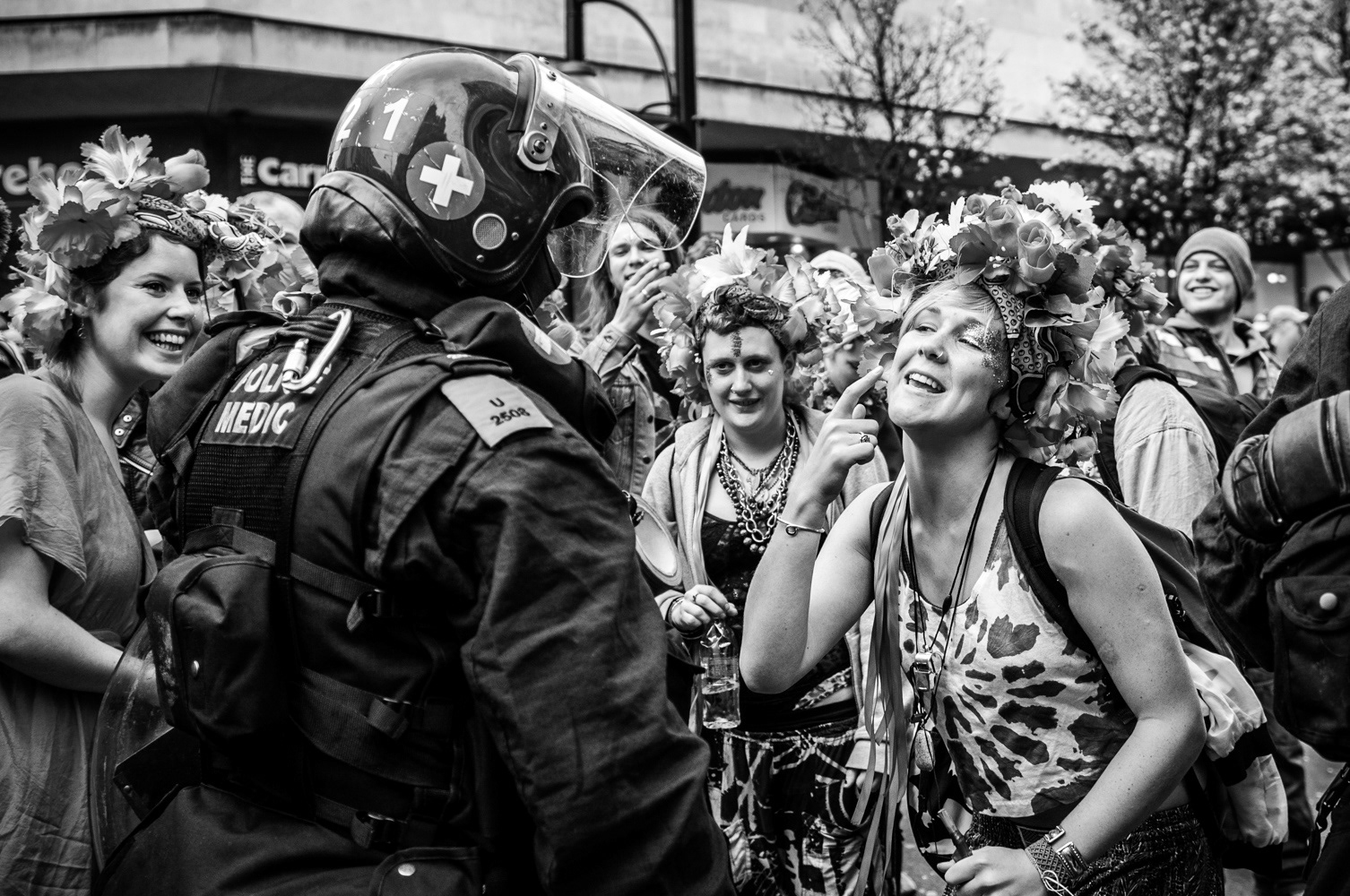 Protester invites police office to kiss her on the cheek at the 2011 anti-cuts protest in London. Image © Nik van Herpt