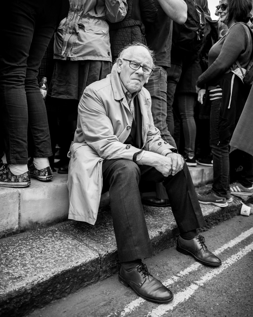 Well-dressed older man at Parliament Square Garden sitting on the pavement, on the “Put It To The People March” in London, 2019. Image © Nik van Herpt