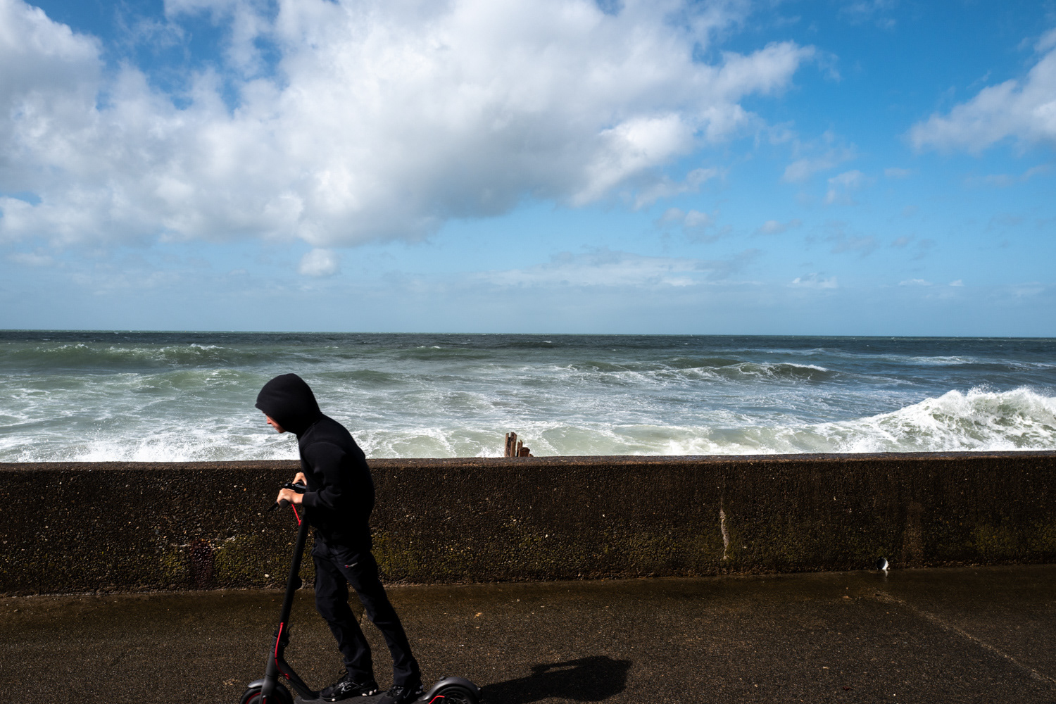 Boy on scooter beside beach. Barmouth, Wales. Image © Nik van Herpt