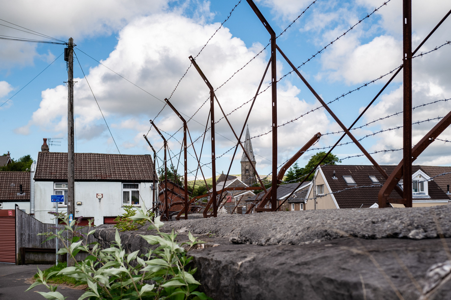 View of church through barbed wire. Merthyr Tydfil, Wales. Image © Nik van Herpt